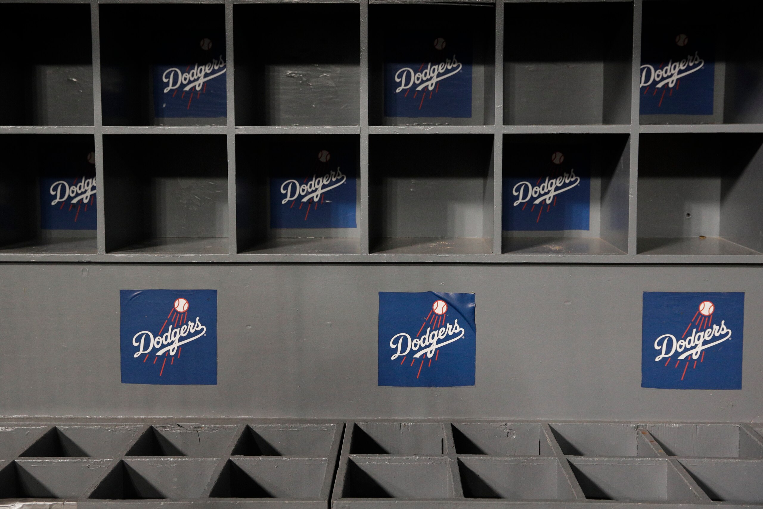 Empty bat and helmet racks are seen in the Los Angeles Dodgers dugout after the team's Game 5 of the World Series baseball game against the Boston Red Sox on Sunday, Oct. 28, 2018, in Los Angeles. (AP Photo/Jae C. Hong)