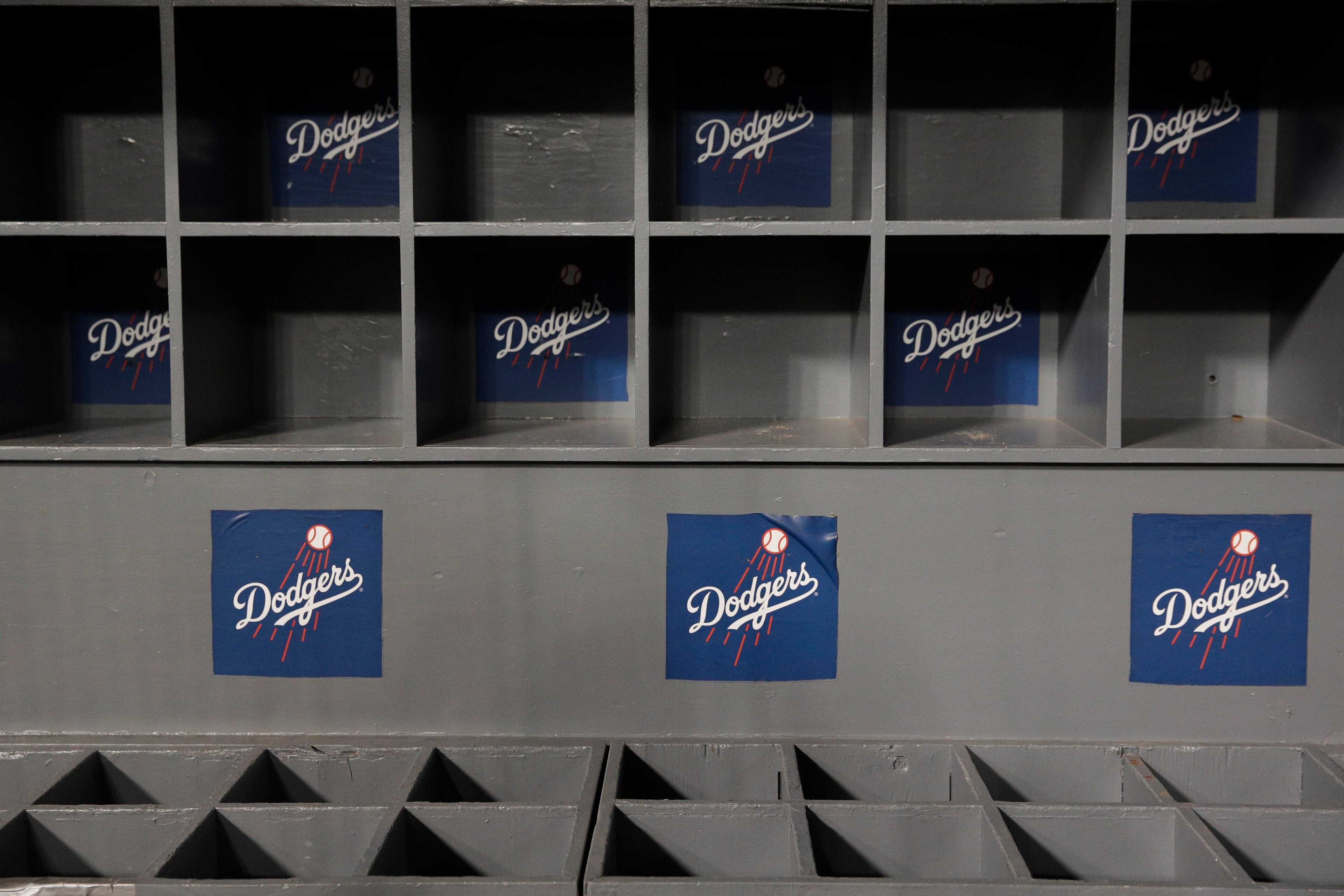 Empty bat and helmet racks are seen in the Los Angeles Dodgers dugout after the team's Game 5 of the World Series baseball game against the Boston Red Sox on Sunday, Oct. 28, 2018, in Los Angeles. (AP Photo/Jae C. Hong)