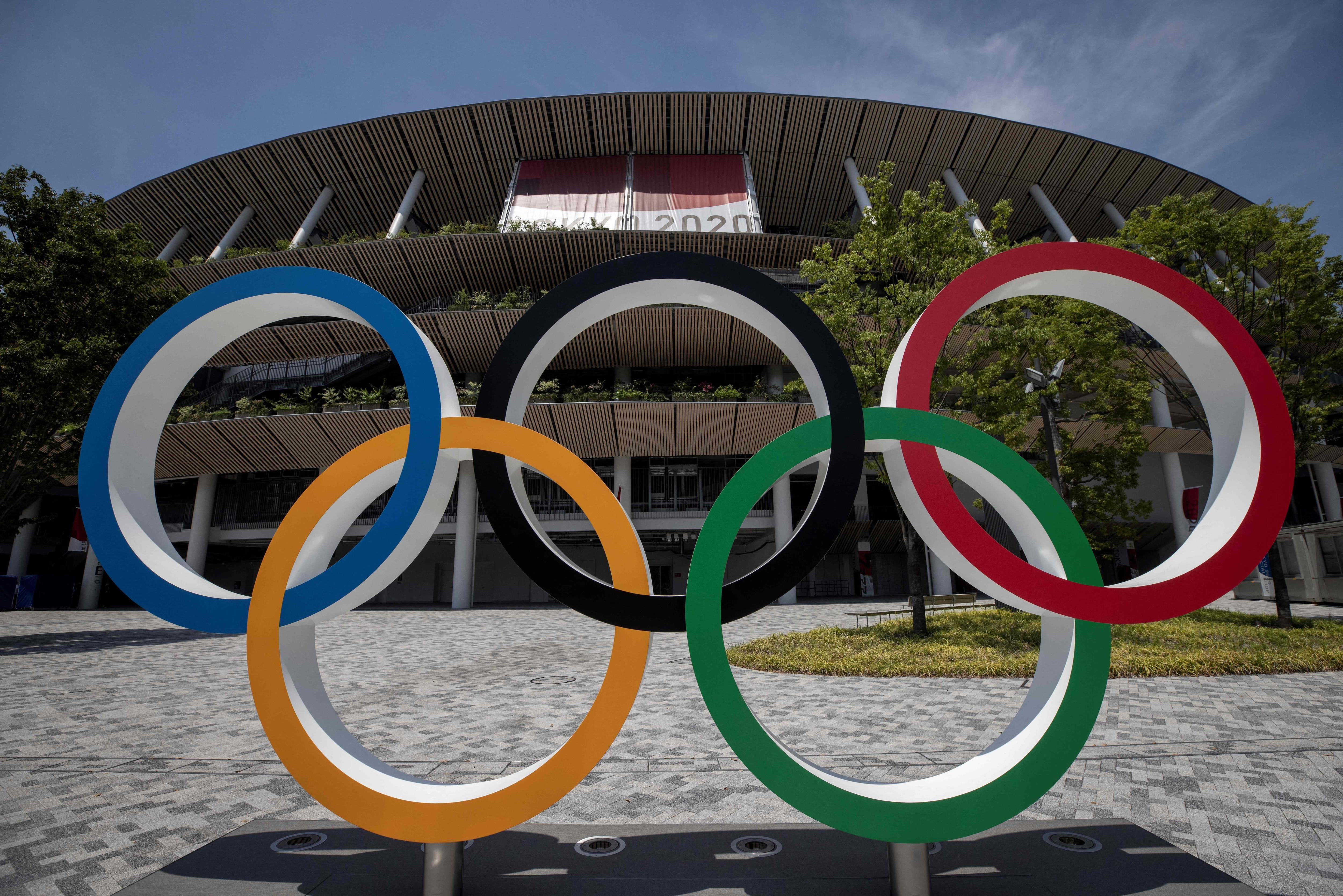 This picture shows the Olympic rings standing in front of the Olympic Stadium in Tokyo on July 20, 2021 ahead of the Tokyo 2020 Olympic Games. (Photo by Behrouz MEHRI / AFP) (Photo by BEHROUZ MEHRI/AFP via Getty Images)