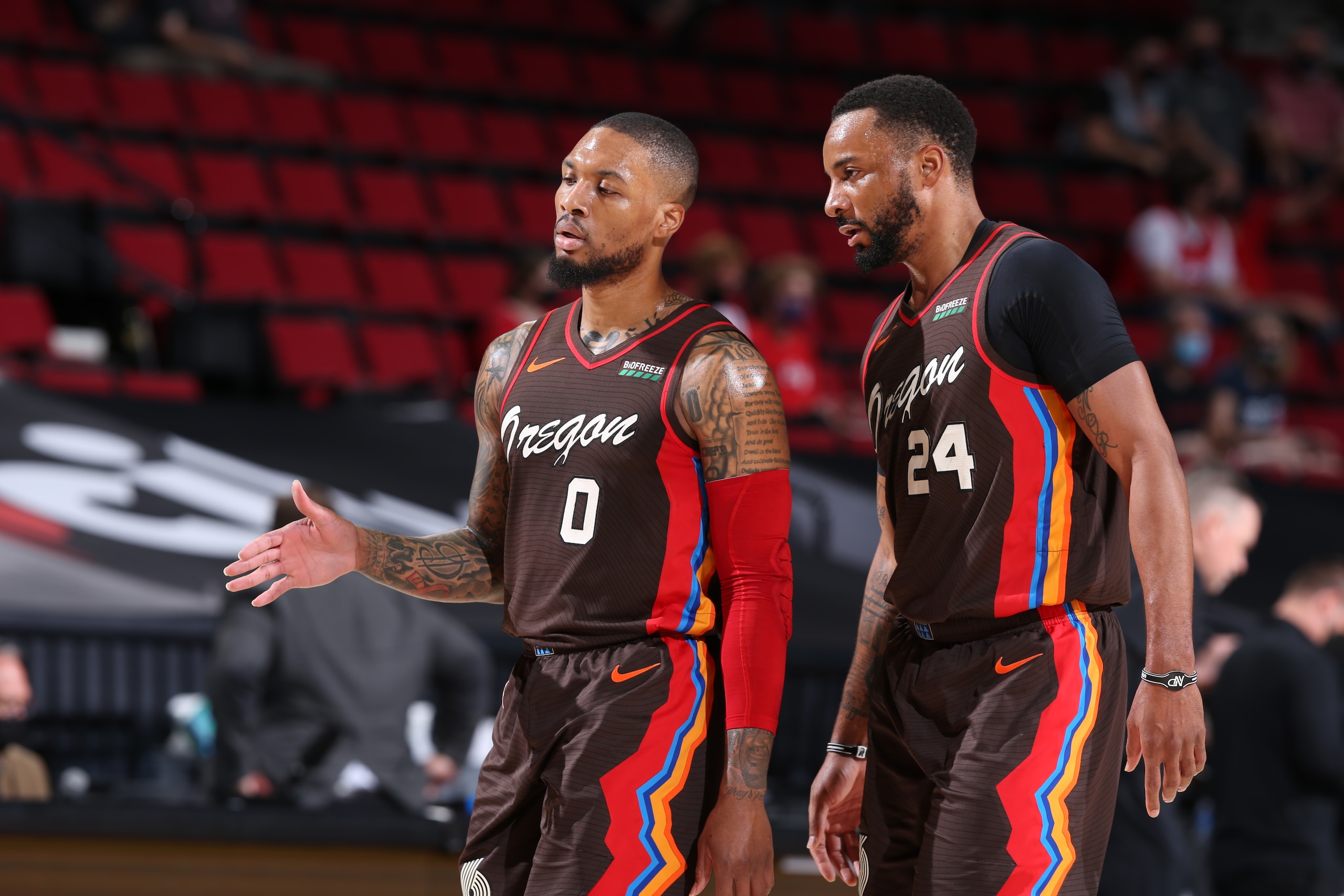 PORTLAND, OR - JUNE 3: Damian Lillard #0 and Norman Powell #24 of the Portland Trail share a conversation during the game against the Denver Nuggets on June 3, 2021 at the Moda Center Arena in Portland, Oregon. NOTE TO USER: User expressly acknowledges and agrees that, by downloading and or using this photograph, user is consenting to the terms and conditions of the Getty Images License Agreement. Mandatory Copyright Notice: Copyright 2021 NBAE (Photo by Sam Forencich/NBAE via Getty Images)