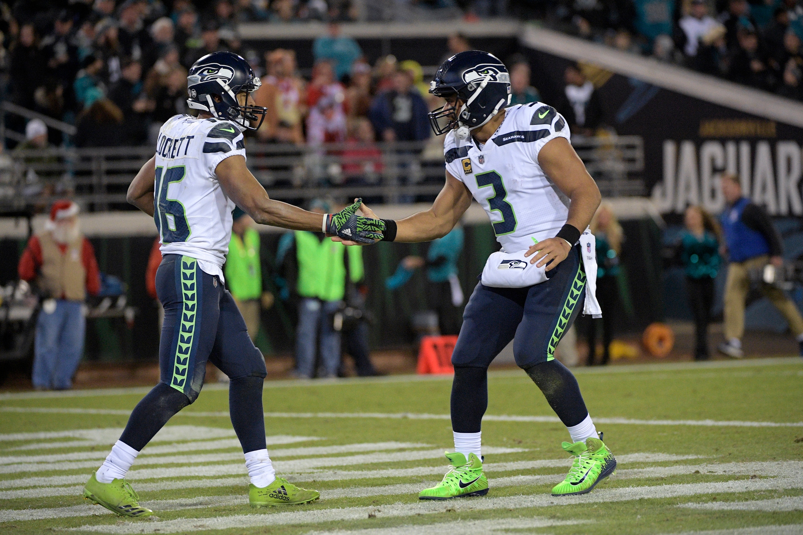 Seattle Seahawks wide receiver Tyler Lockett (16) is congratulated by quarterback Russell Wilson (3) after the two connected on a pass for a touchdown during the second half of an NFL football game against the Jacksonville Jaguars Sunday, Dec. 10, 2017, in Jacksonville, Fla. The Jaguars won 30-24. (AP Photo/Phelan M. Ebenhack)