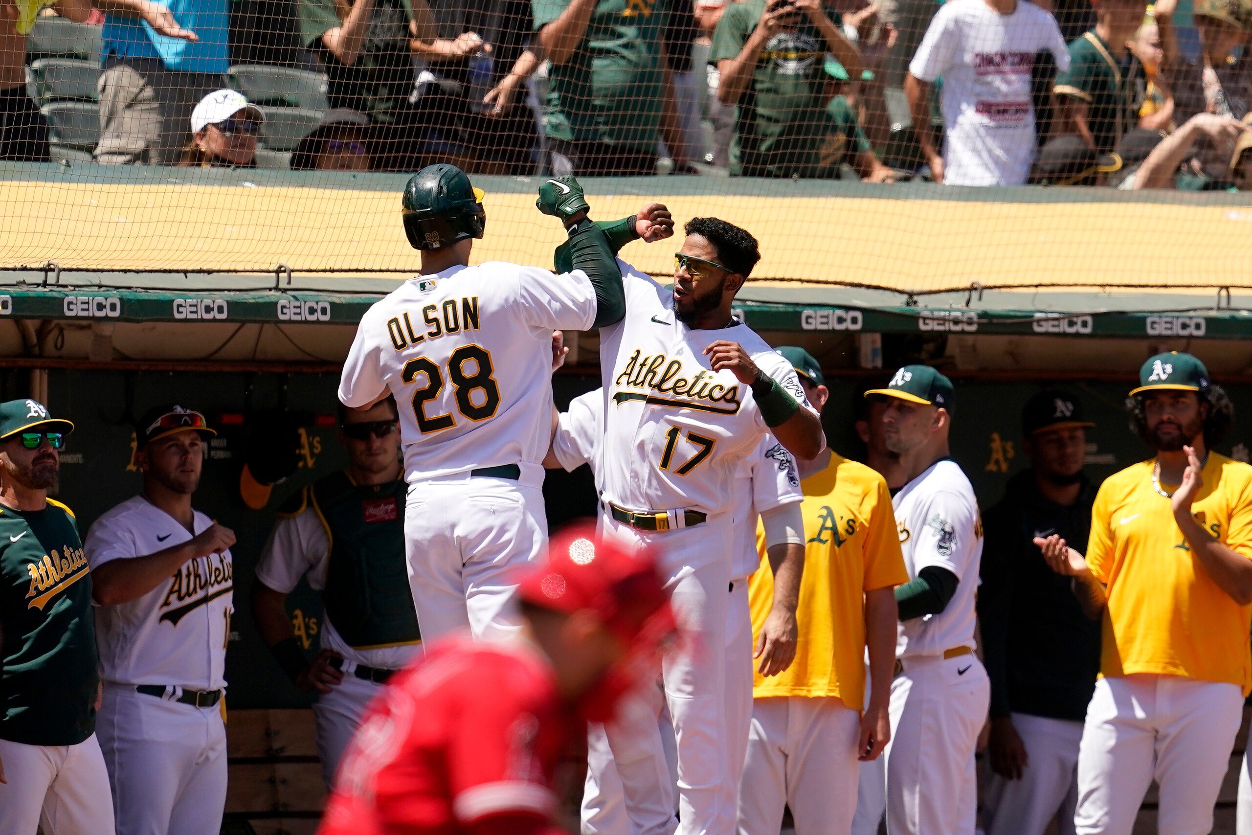 Oakland Athletics' Matt Olson (28) is congratulated by Elvis Andrus (17) after hitting a home run against the Los Angeles Angels during the fourth inning of a baseball game in Oakland, Calif., Tuesday, July 20, 2021. (AP Photo/Jeff Chiu)