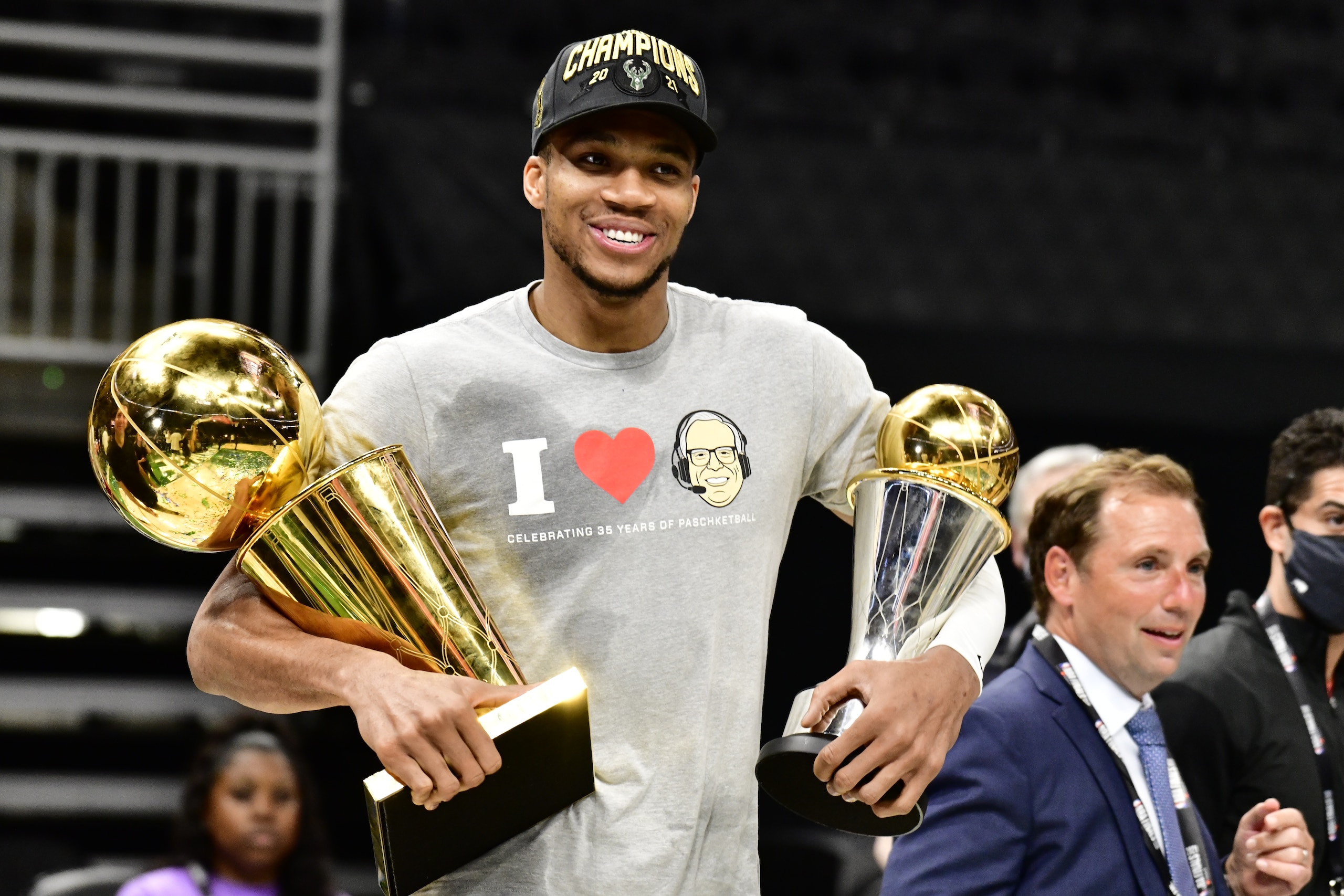 MILWAUKEE, WI - JULY 20: Giannis Antetokounmpo #34 of the Milwaukee Bucks holds the Bill Russell NBA Finals MVP Award and Larry O'Brien Trophy after defeating the Phoenix Suns in Game Six to win the 2021 NBA Finals during Game Six of the 2021 NBA Finals on July 20, 2021 at the Fiserv Forum Center in Milwaukee, Wisconsin. NOTE TO USER: User expressly acknowledges and agrees that, by downloading and or using this Photograph, user is consenting to the terms and conditions of the Getty Images License Agreement. Mandatory Copyright Notice: Copyright 2021 NBAE (Photo by Barry Gossage/NBAE via Getty Images).