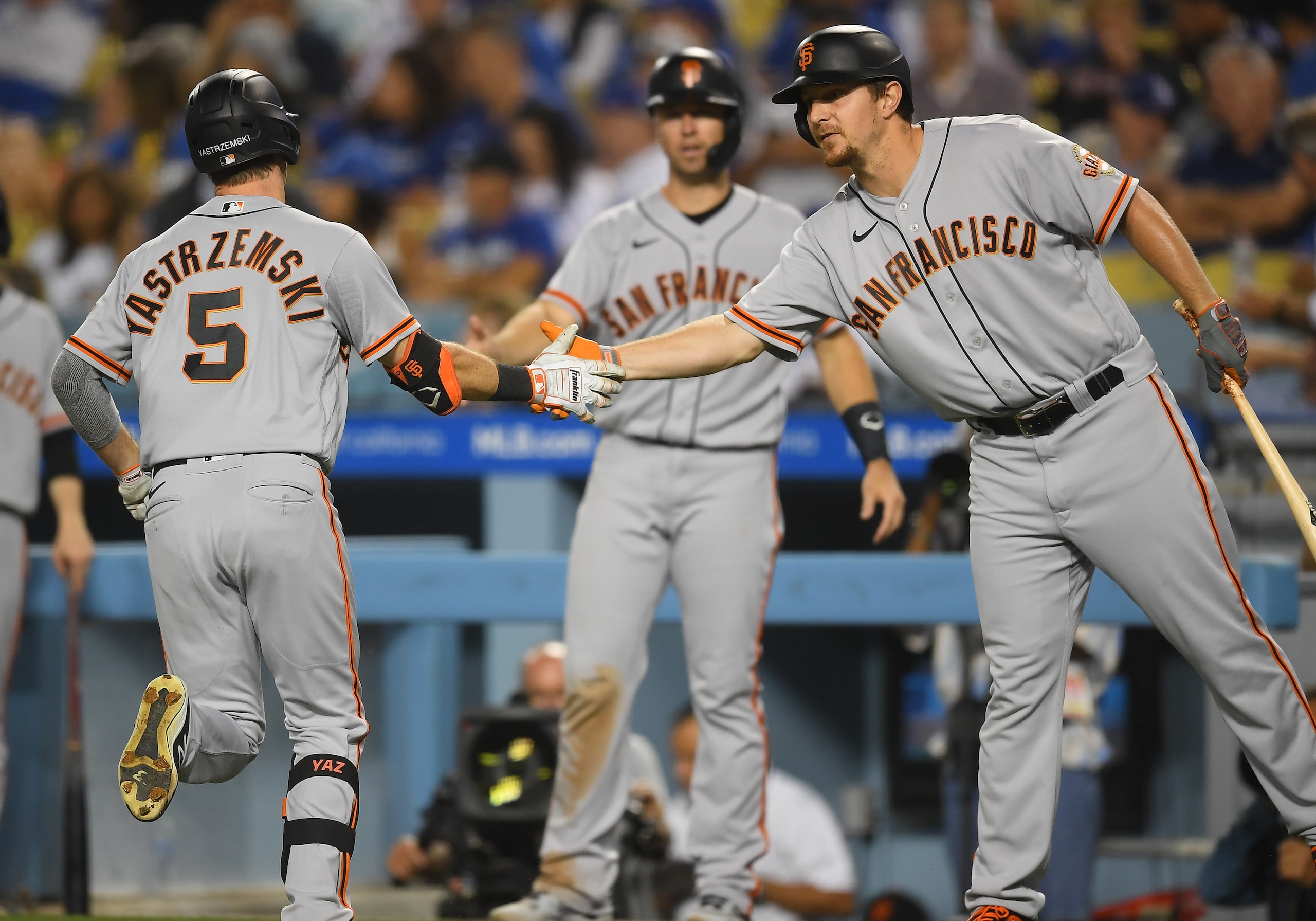 LOS ANGELES, CA - JULY 20: Mike Yastrzemski #5 is greeted by Buster Posey #28 and Alex Dickerson #12 of the San Francisco Giants after hitting a two run home run in the fifth inning against the Los Angeles Dodgers at Dodger Stadium on July 20, 2021 in Los Angeles, California. (Photo by Jayne Kamin-Oncea/Getty Images)