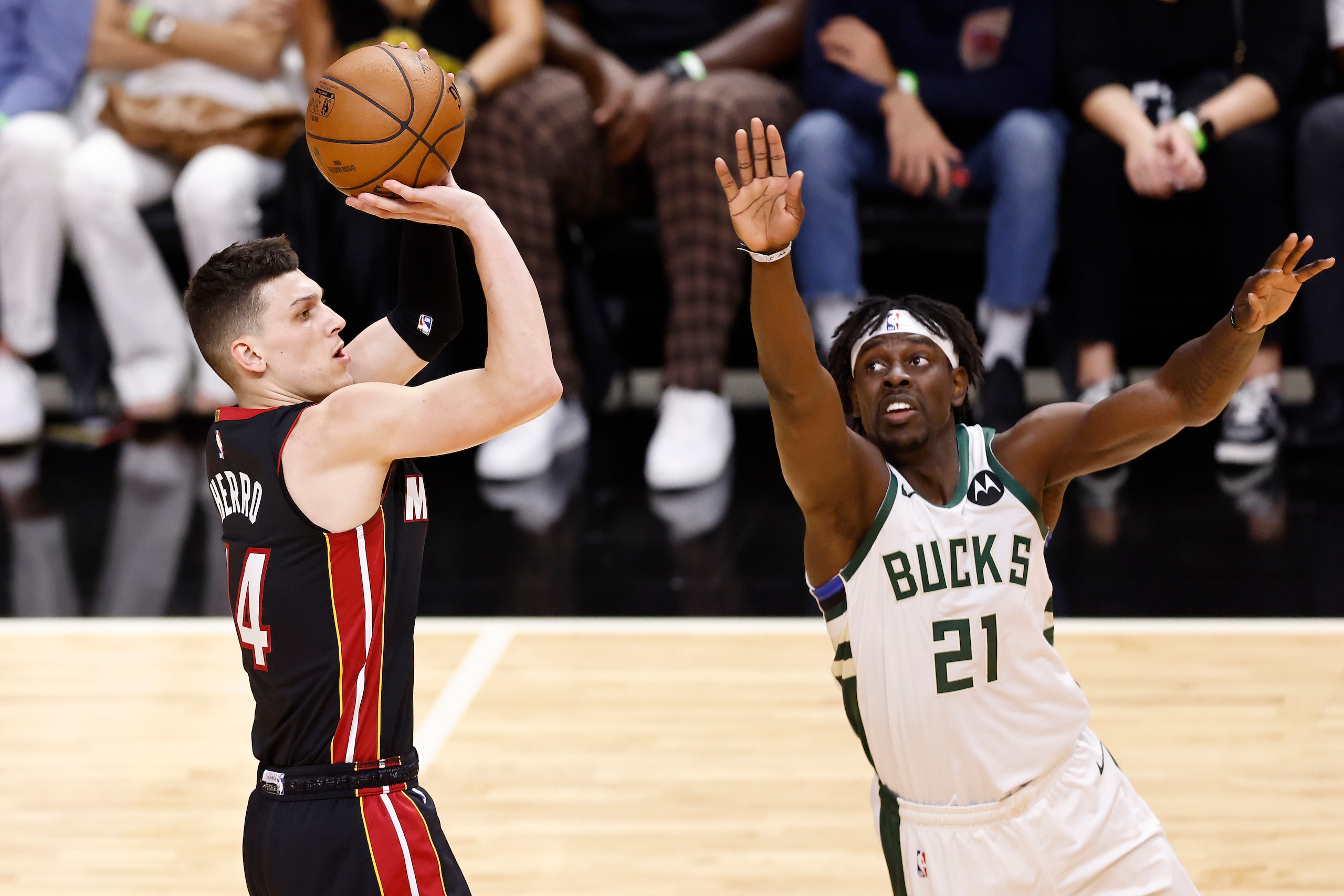 MIAMI, FLORIDA - MAY 27: Tyler Herro #14 of the Miami Heat shoots over Jrue Holiday #21 of the Milwaukee Bucks during the first quarter in Game Three of the Eastern Conference first-round playoff series at American Airlines Arena on May 27, 2021 in Miami, Florida. NOTE TO USER: User expressly acknowledges and agrees that, by downloading and or using this photograph, User is consenting to the terms and conditions of the Getty Images License Agreement. (Photo by Michael Reaves/Getty Images) MIAMI, FLORIDA - MAY 27: Tyler Herro #14 of the Miami Heat shoots over Jrue Holiday #21 of the Milwaukee Bucks during the first quarter in Game Three of the Eastern Conference first-round playoff series at American Airlines Arena on May 27, 2021 in Miami, Florida. NOTE TO USER: User expressly acknowledges and agrees that, by downloading and or using this photograph, User is consenting to the terms and conditions of the Getty Images License Agreement. (Photo by Michael Reaves/Getty Images)