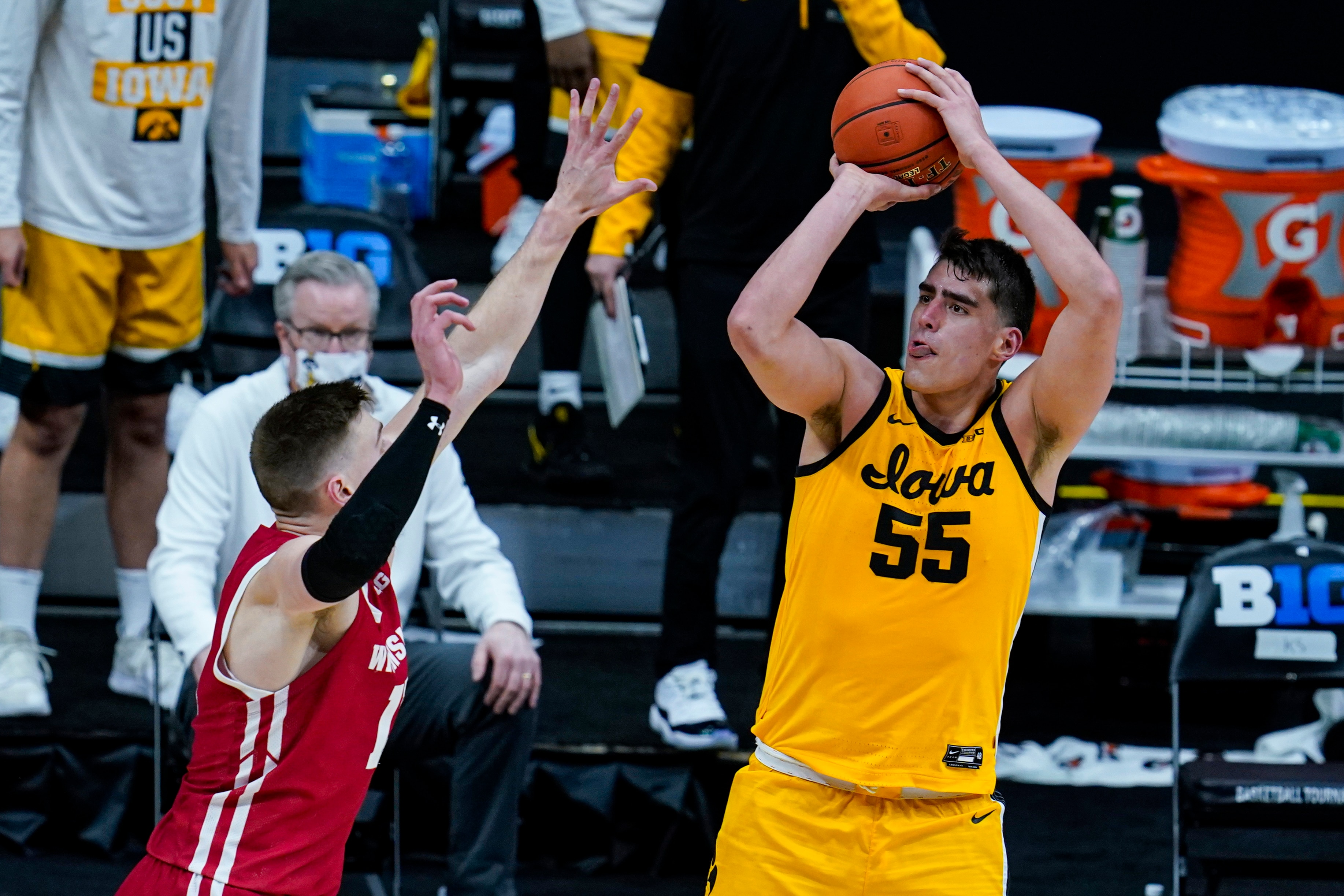 Iowa center Luka Garza (55) shoots over Wisconsin forward Micah Potter (11) in the second half of an NCAA college basketball game at the Big Ten Conference tournament in Indianapolis, Friday, March 12, 2021. (AP Photo/Michael Conroy)