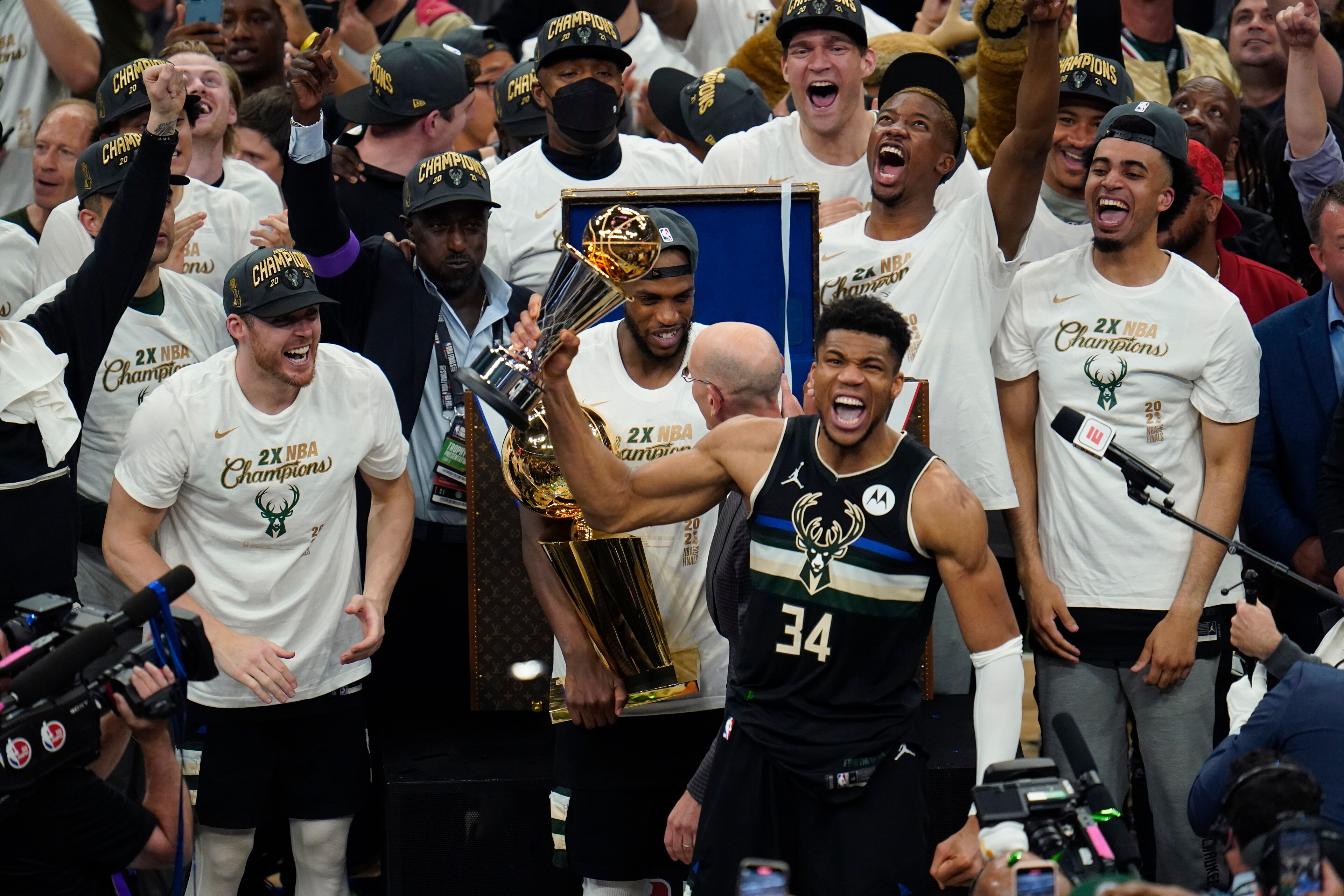 Milwaukee Bucks forward Giannis Antetokounmpo (34) holds up the MVP trophy after defeating the Phoenix Suns in Game 6 of basketball's NBA Finals in Milwaukee, Tuesday, July 20, 2021. The Bucks won 105-98. (AP Photo/Paul Sancya)