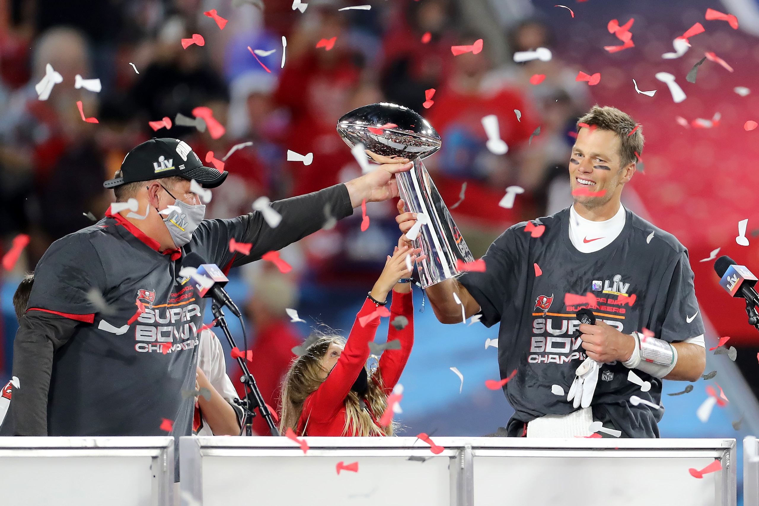 TAMPA, FL - FEBRUARY 07: Super Bowl MVP Tom Brady (12) of the Buccaneers accepts the Lombardi Trophy from General Manager Jason Licht after the Super Bowl LV game between the Kansas City Chiefs and the Tampa Bay Buccaneers on February 7, 2021 at Raymond James Stadium, in Tampa, FL. (Photo by Cliff Welch/Icon Sportswire via Getty Images)