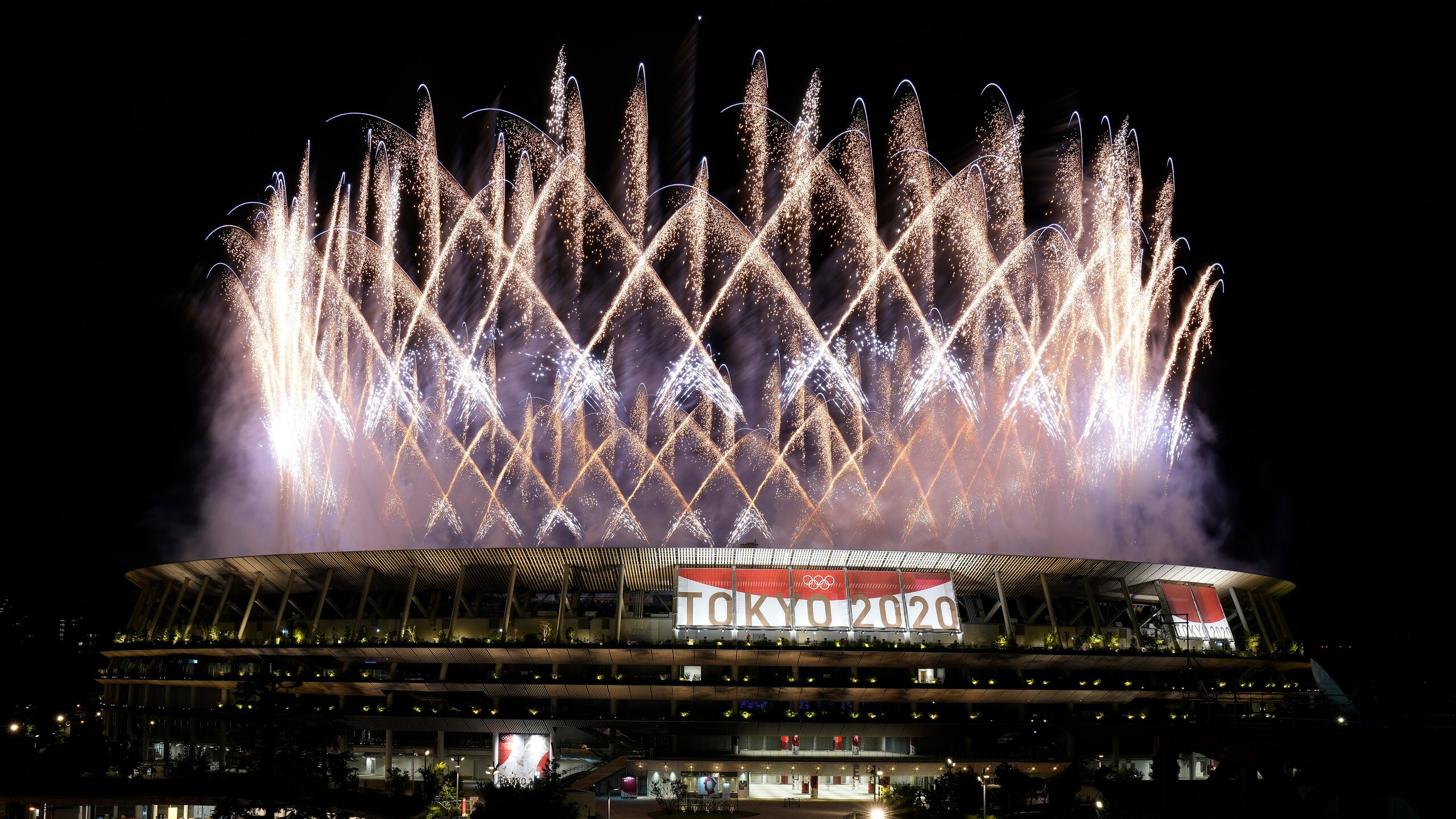 Fireworks illuminate over the National Stadium during the opening ceremony of the 2020 Summer Olympics, Friday, July 23, 2021, in Tokyo. (AP Photo/Shuji Kajiyama)