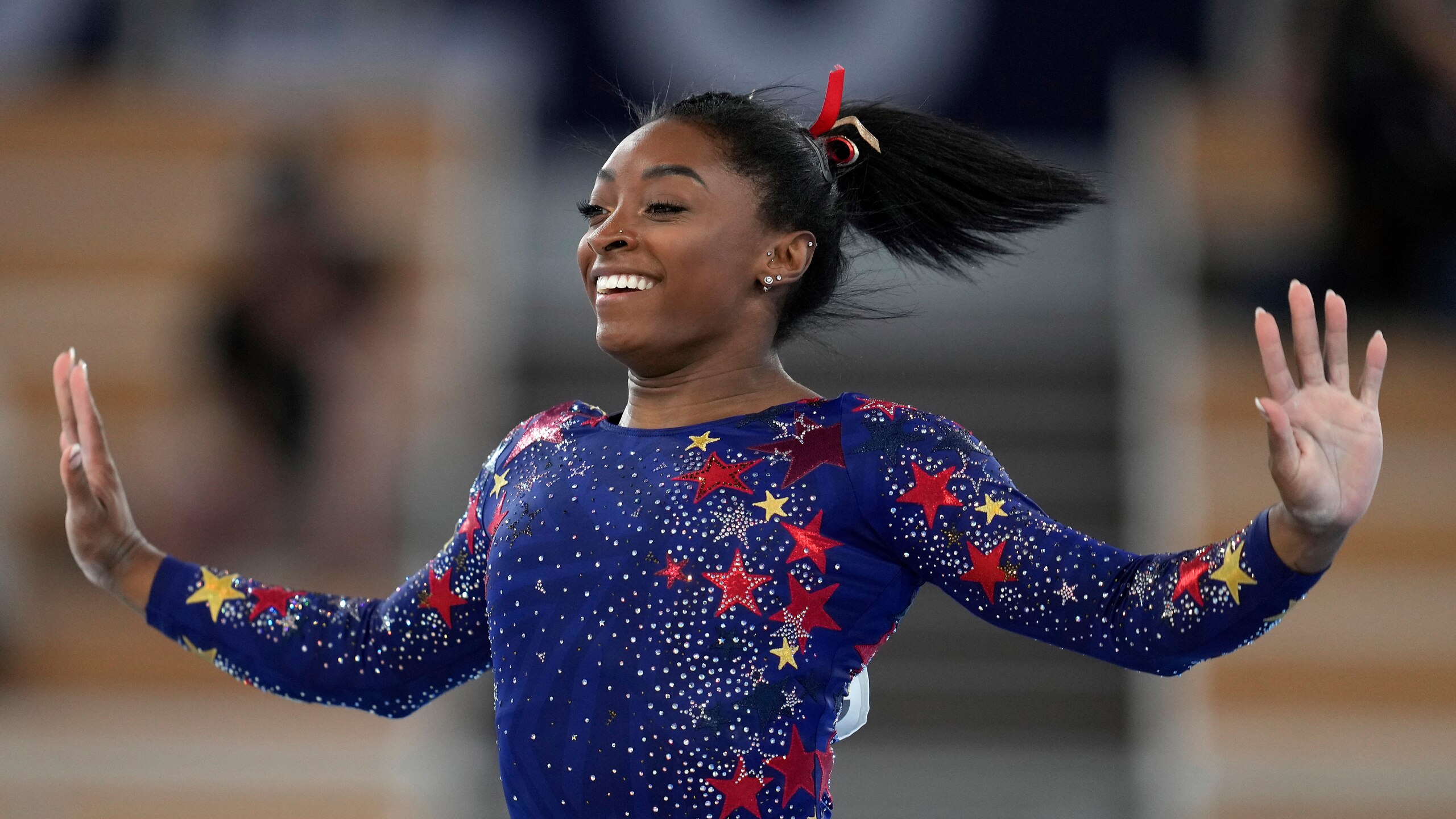 Simone Biles, of the United States, performs on the floor during the women's artistic gymnastic qualifications at the 2020 Summer Olympics, Sunday, July 25, 2021, in Tokyo. (AP Photo/Natacha Pisarenko)