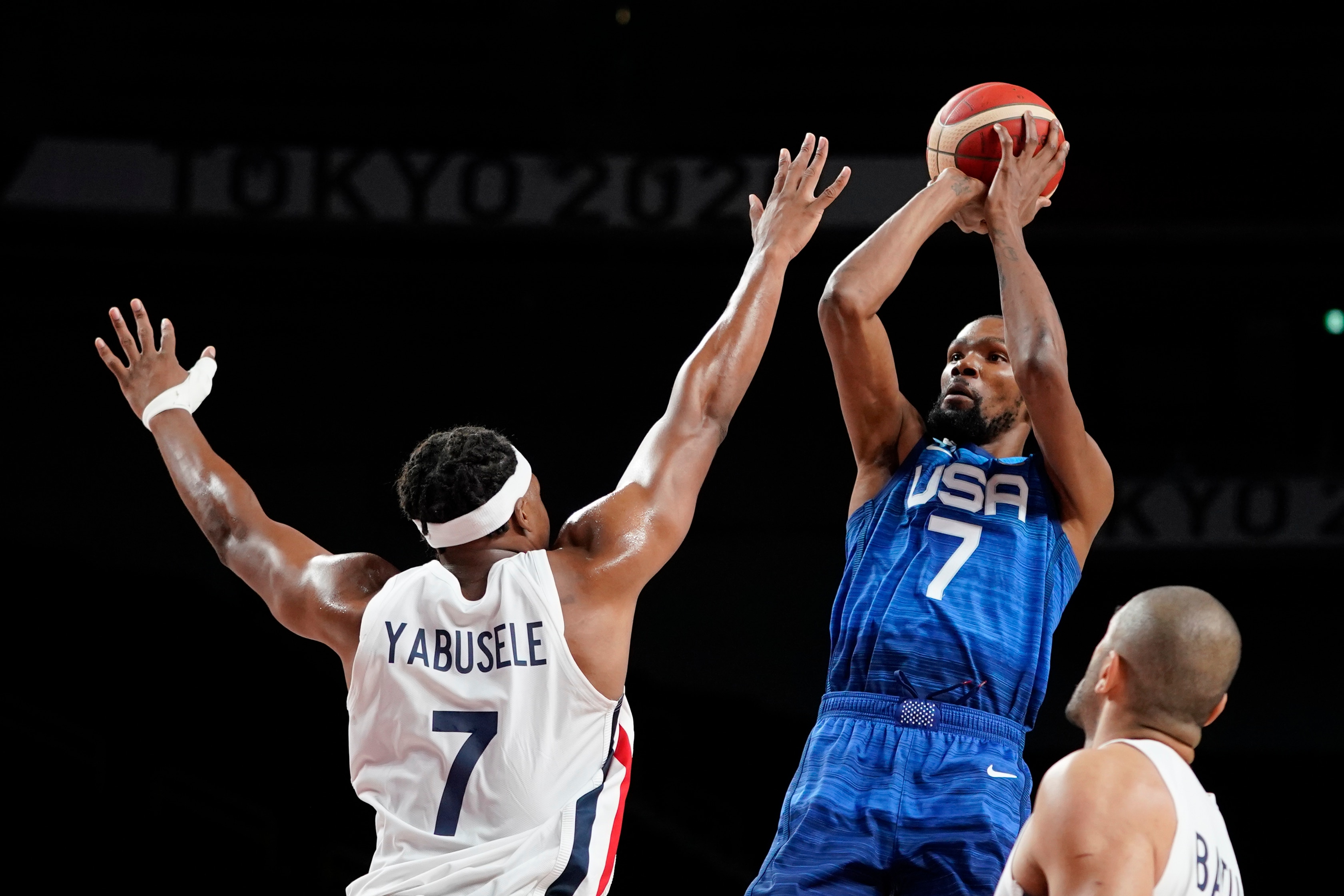 United States' Kevin Durant shoots over France's Guerschon Yabusele, left, during a men's basketball preliminary round game at the 2020 Summer Olympics, Sunday, July 25, 2021, in Saitama, Japan. (AP Photo/Charlie Neibergall)