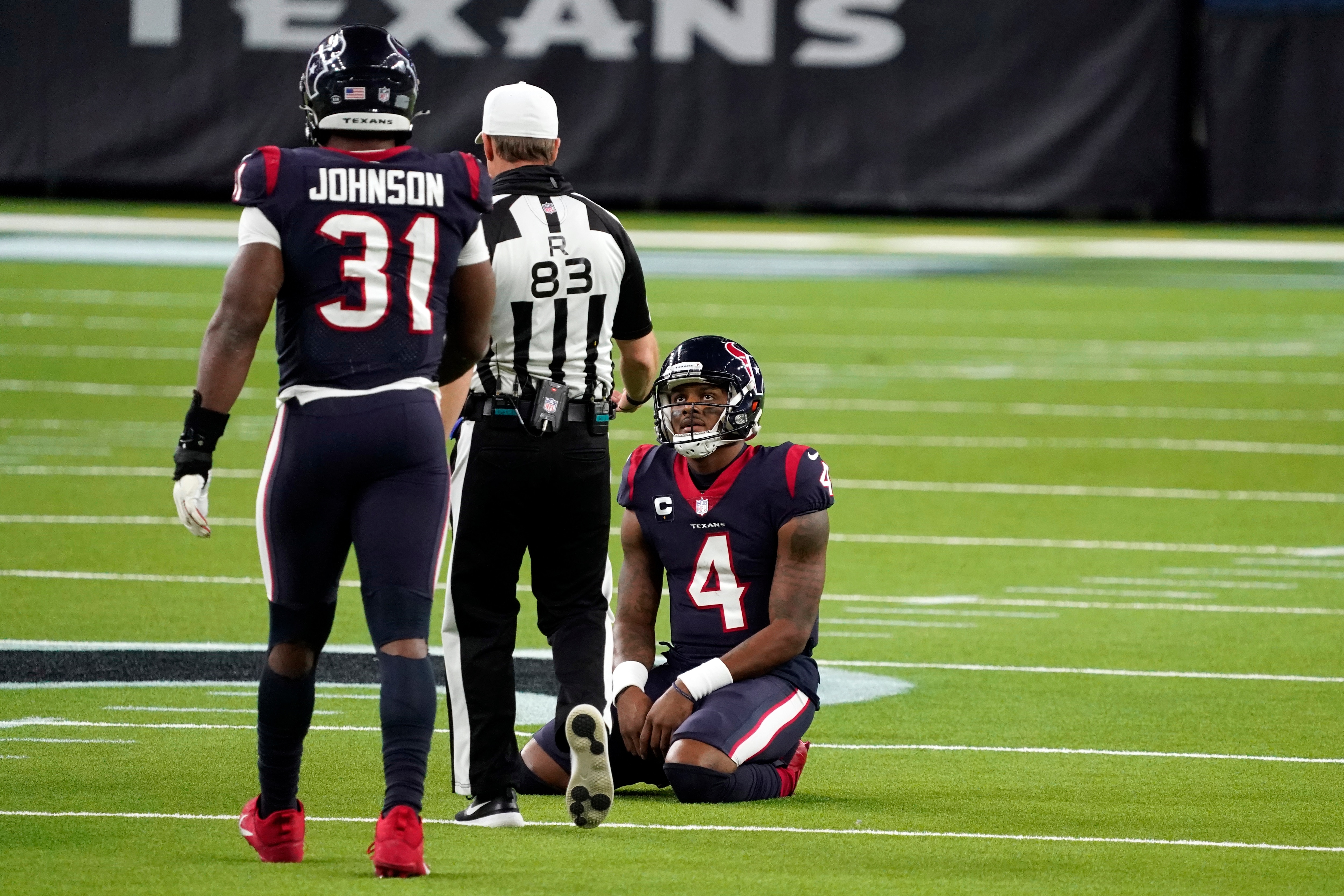 Houston Texans quarterback Deshaun Watson (4) looks up referee Shawn  Hochuli (83) during the second half of an NFL football game against the Tennessee Titans Sunday, Jan. 3, 2021, in Houston. The Titans won 41-38. (AP Photo/Sam Craft)