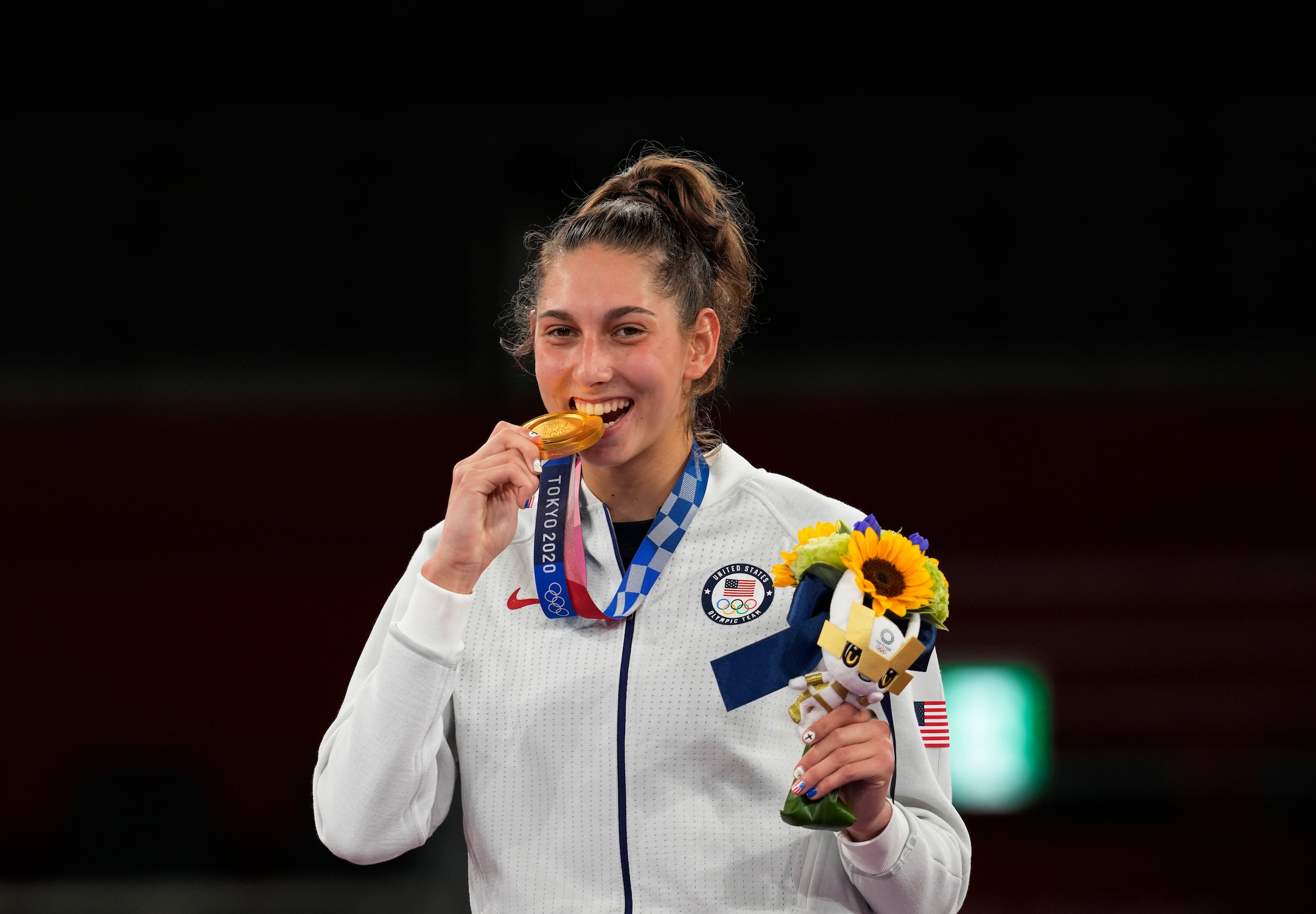 United States's Anastasija Zolotic holds her gold medal during a ceremony for the taekwondo women's 57kg at the 2020 Summer Olympics, Sunday, July 25, 2021, in Tokyo, Japan. (AP Photo/Themba Hadebe)