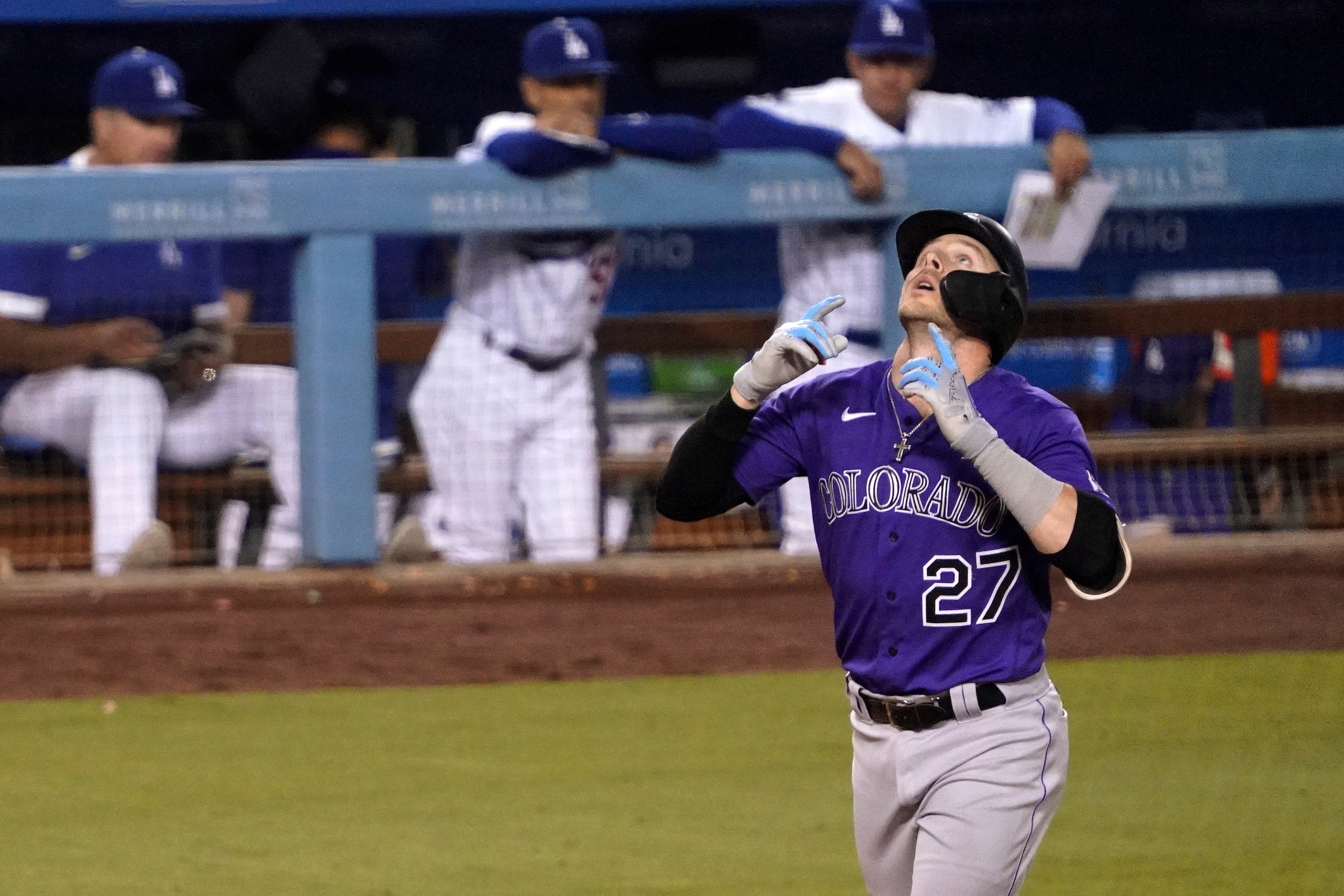 Colorado Rockies' Trevor Story looks up as he approaches home on a solo home run during the sixth inning of a baseball game against the Los Angeles Dodgers on Friday, July 23, 2021, in Los Angeles. (AP Photo/Mark J. Terrill)