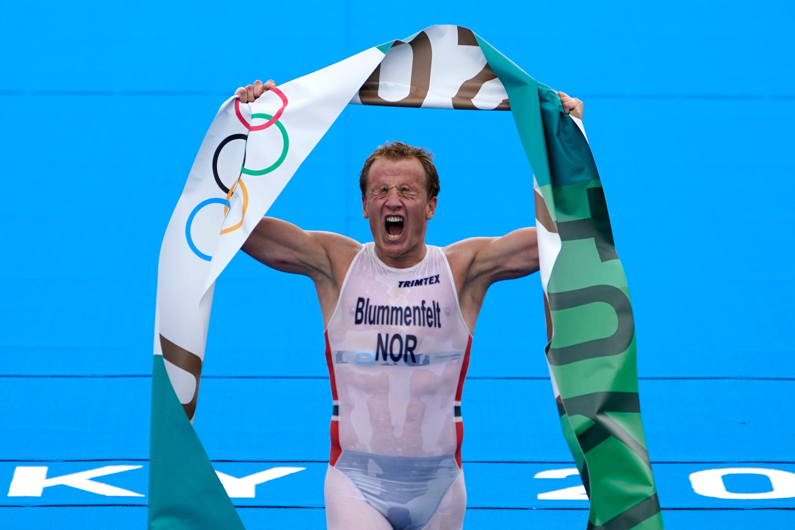 Kristian Blummenfelt of Norway reacts after crossing the finish line to win the gold medal during the men's individual triathlon at the 2020 Summer Olympics, Monday, July 26, 2021, in Tokyo, Japan. (AP Photo/David Goldman)