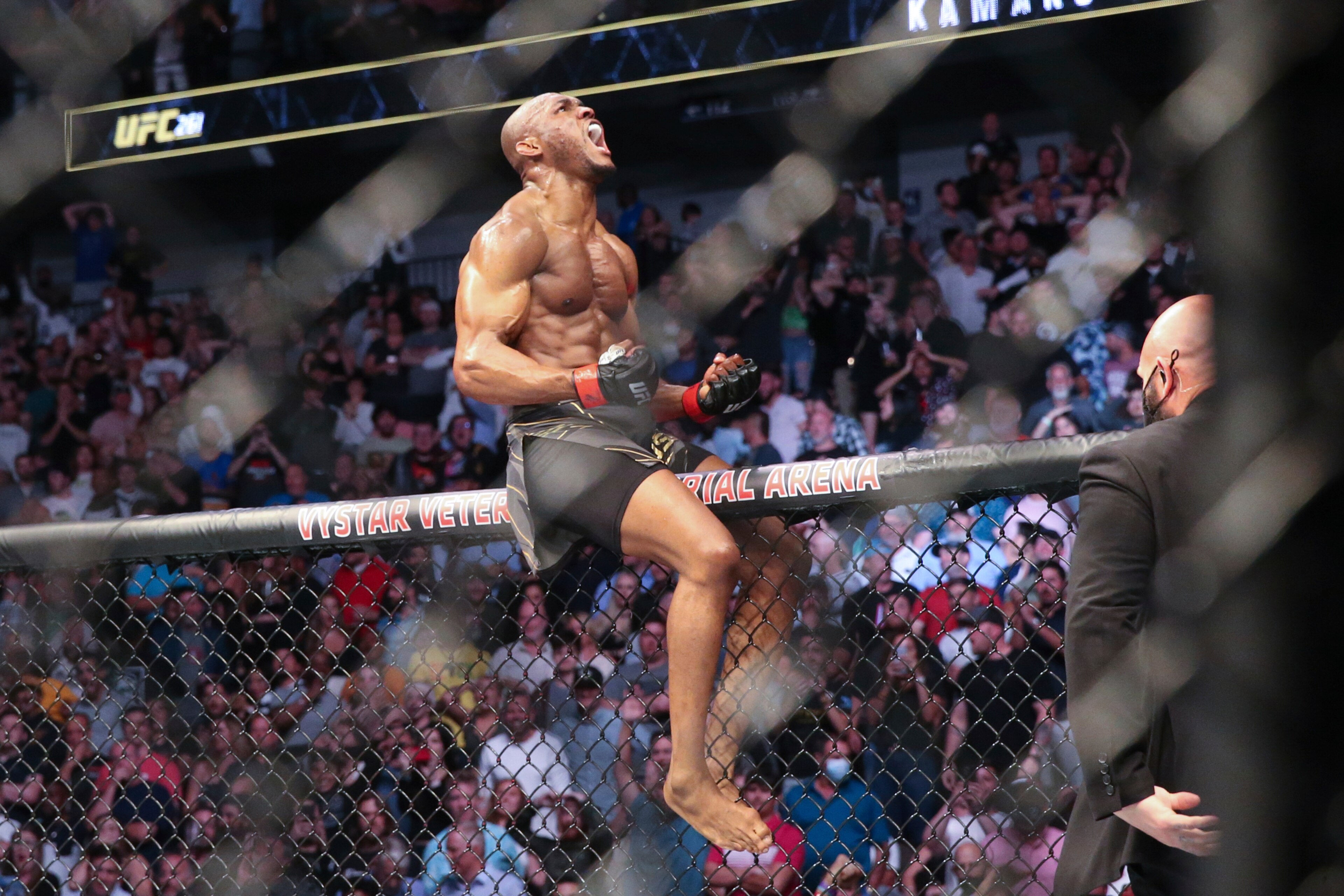 Kamaru Usman celebrates his win atop the octagon fence after a UFC 261 mixed martial arts bout against Jorge Masvidal early Sunday, April 25, 2021, in Jacksonville, Fla. (AP Photo/Gary McCullough) Kamaru Usman celebrates his win atop the octagon fence after a UFC 261 mixed martial arts bout against Jorge Masvidal early Sunday, April 25, 2021, in Jacksonville, Fla. (AP Photo/Gary McCullough)
