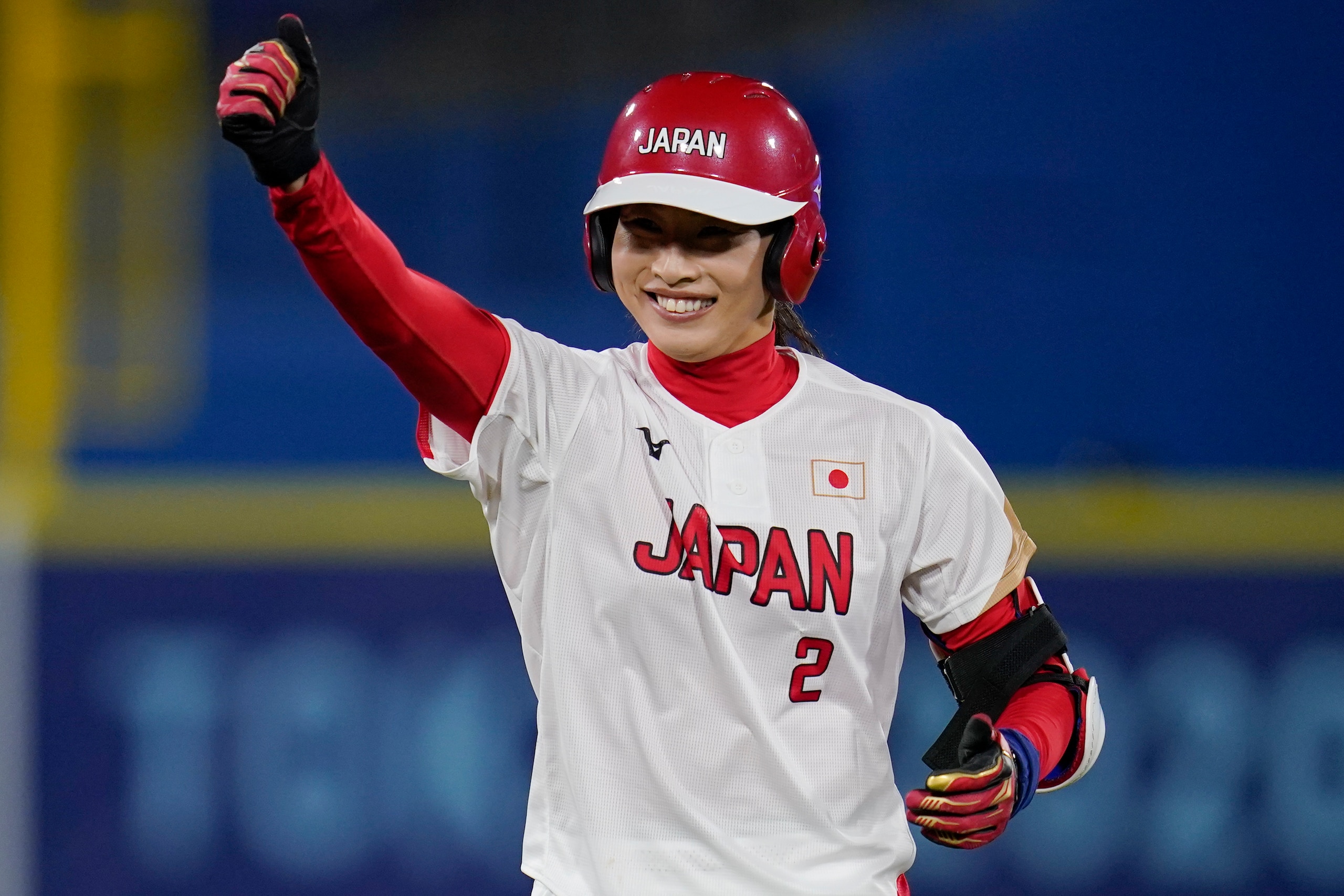Japan's Saki Yamazaki reacts after hitting a double in the second inning of a softball game against the United States at the 2020 Summer Olympics, Tuesday, July 27, 2021, in Yokohama, Japan. (AP Photo/Sue Ogrocki)