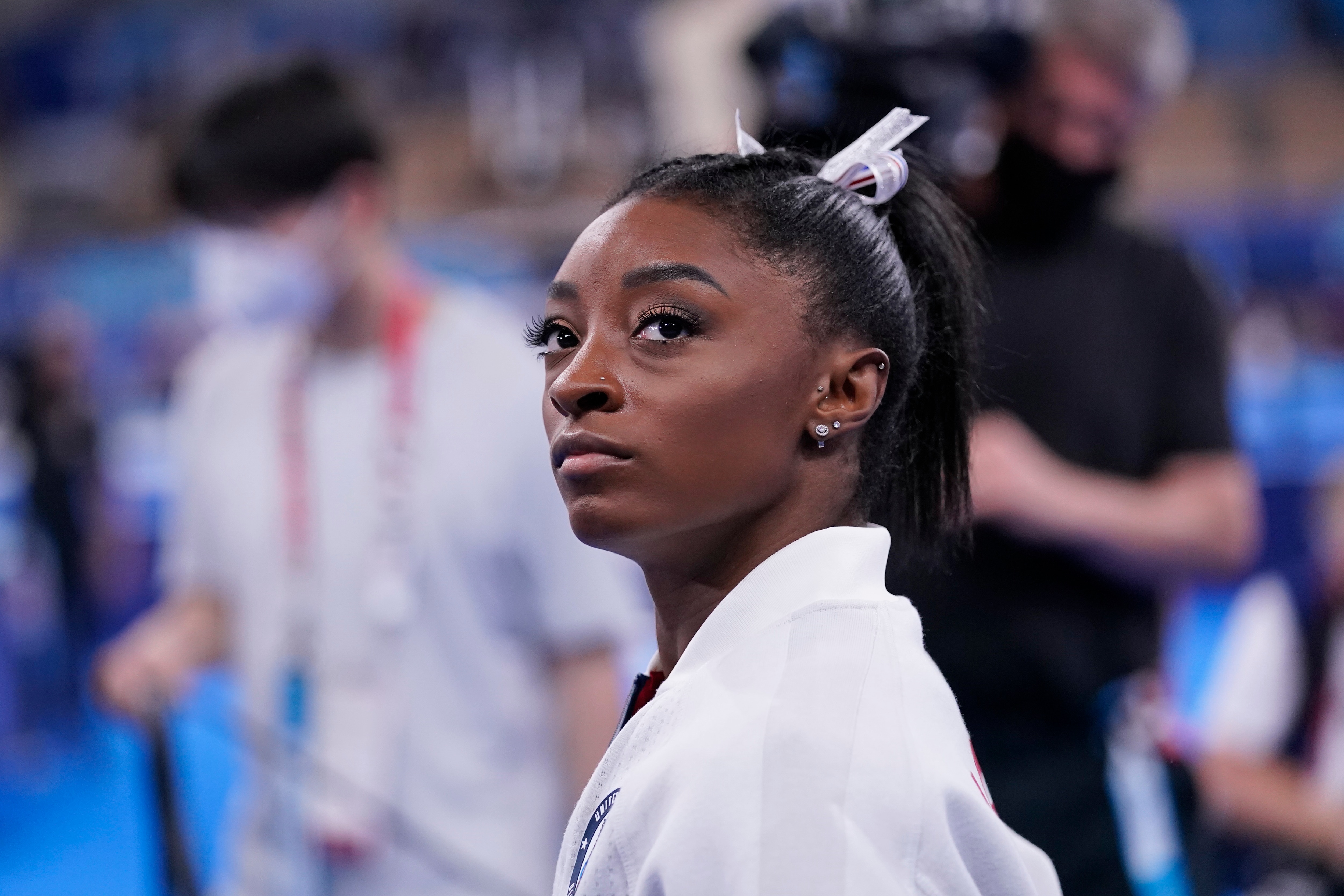 Simone Biles, of the United States, waits for her turn to perform during the artistic gymnastics women's final at the 2020 Summer Olympics, Tuesday, July 27, 2021, in Tokyo. (AP Photo/Gregory Bull)