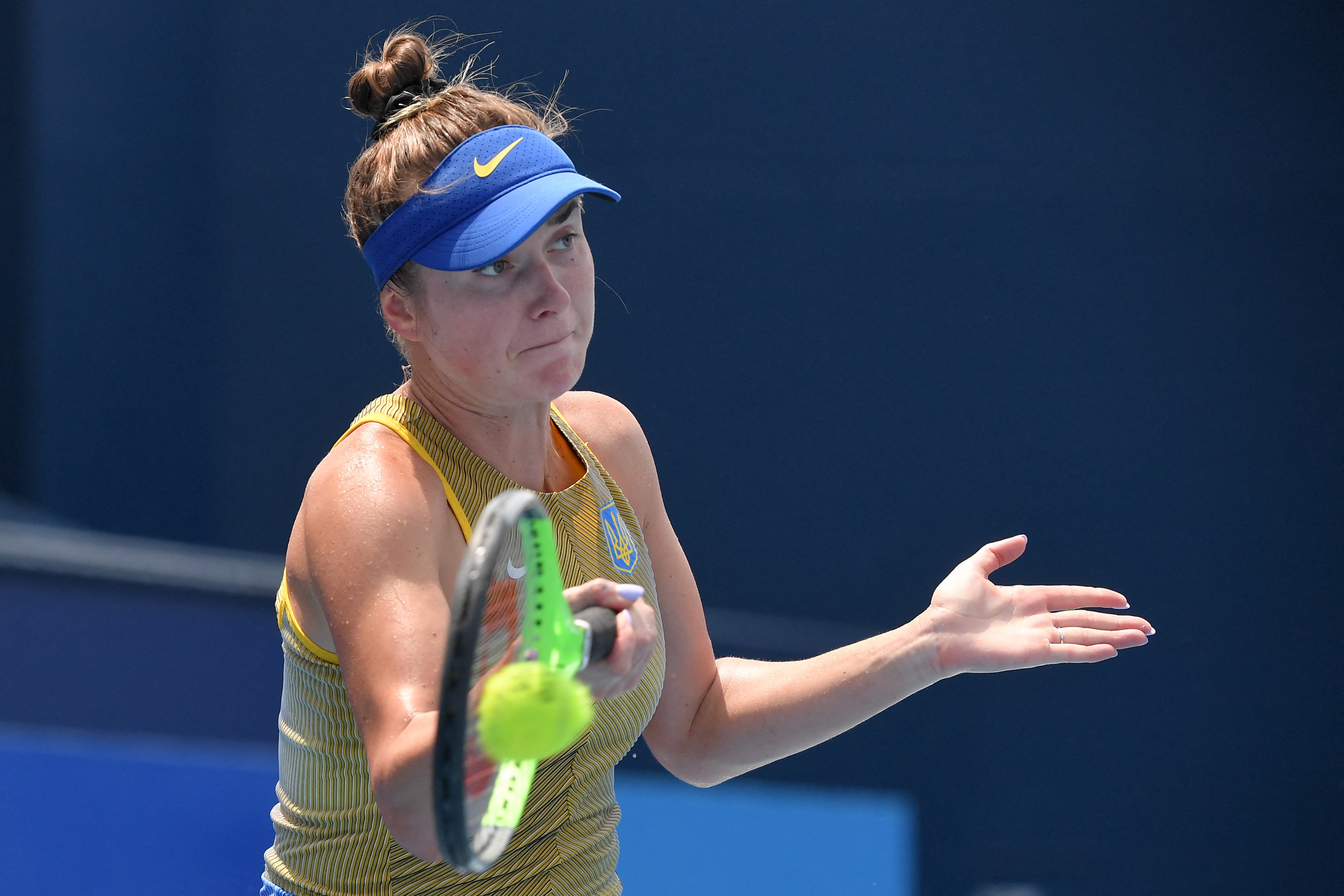 Ukraine's Elina Svitolina returns the ball to Italy's Camila Giorgi during their Tokyo 2020 Olympic Games women's singles quarterfinal tennis match at the Ariake Tennis Park in Tokyo on July 28, 2021. (Photo by Tiziana FABI / AFP) (Photo by TIZIANA FABI/AFP via Getty Images)