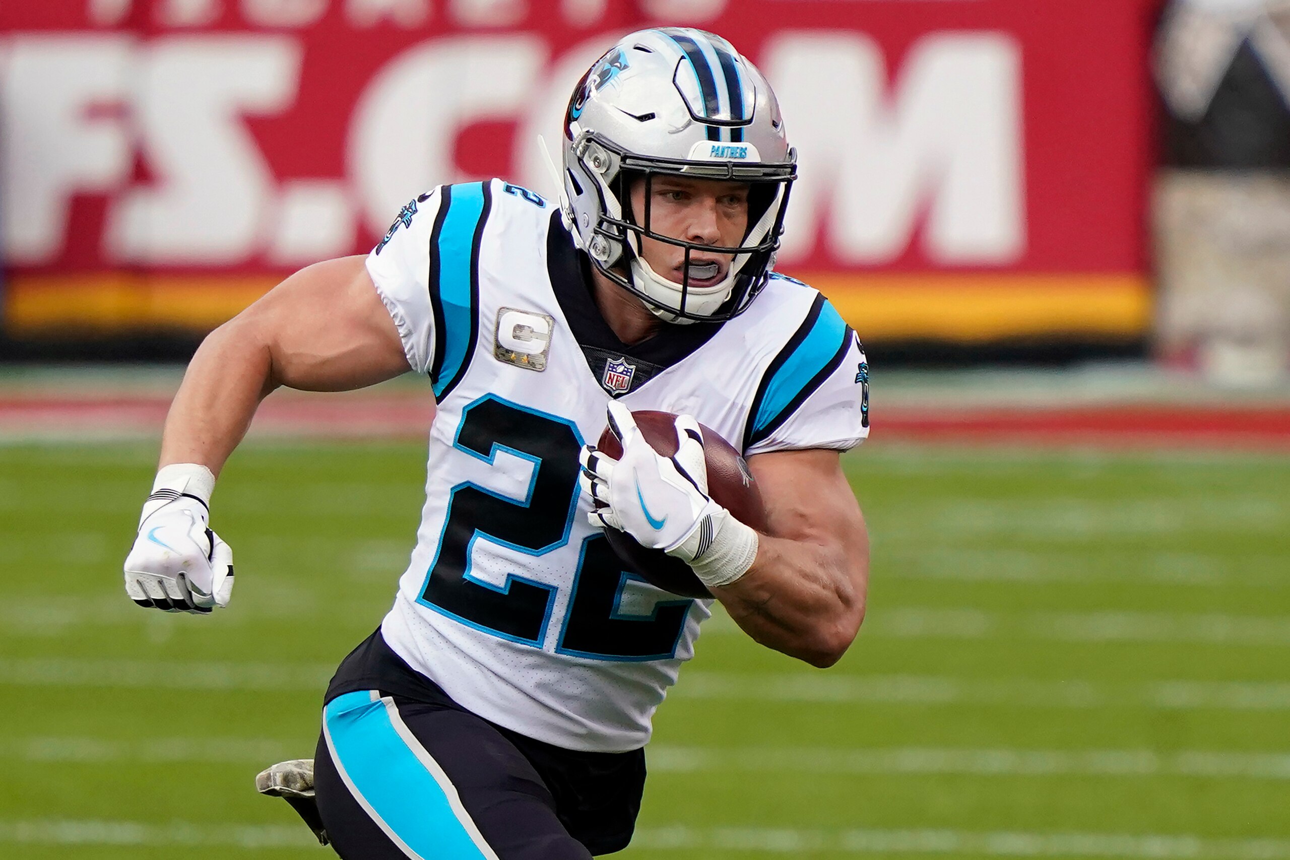 FILE - In this Nov. 8, 2020, file photo, Carolina Panthers running back Christian McCaffrey (22) carries the ball against the Kansas City Chiefs during the first half of an NFL football game in Kansas City, Mo. The Panthers have restructured the contracts of running back Christian McCaffrey and linebacker Shaq Thompson, freeing up more than $11 million in salary-cap space before the start of free agency. (AP Photo/Jeff Roberson, File)