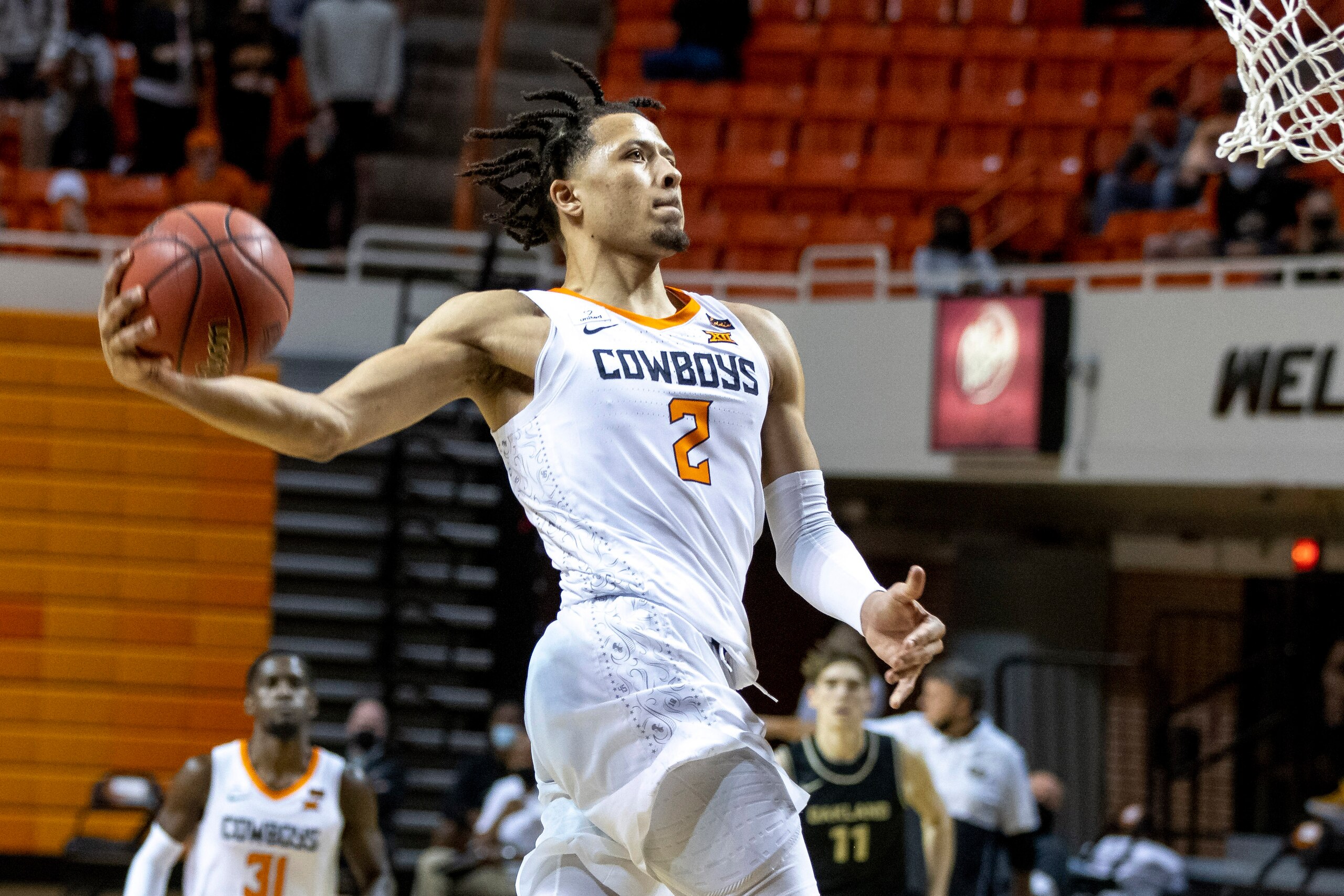 FILE - In this Dec. 5, 2020, file photo, Oklahoma State's Cade Cunningham slam-dunks the ball during the second half of the NCAA college basketball game against Oakland in Stillwater, Okla. Cunningham is The Associated Press Big 12 newcomer of the year and a member of the All-Big 12 first team, announced Tuesday, March 9, 2021. (AP Photo/Mitch Alcala, File) FILE - In this Dec. 5, 2020, file photo, Oklahoma State's Cade Cunningham slam-dunks the ball during the second half of the NCAA college basketball game against Oakland in Stillwater, Okla. Cunningham is The Associated Press Big 12 newcomer of the year and a member of the All-Big 12 first team, announced Tuesday, March 9, 2021. (AP Photo/Mitch Alcala, File)