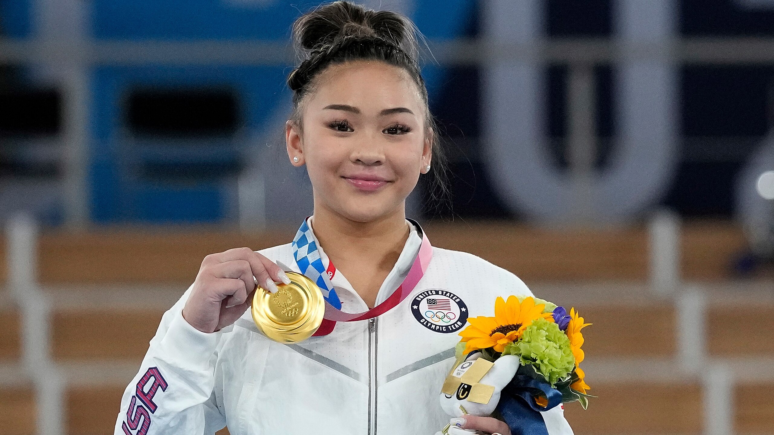 Gold medalist Sunisa Lee of the United States displays her medal for the artistic gymnastics women's all-around at the 2020 Summer Olympics, Thursday, July 29, 2021, in Tokyo. (AP Photo/Gregory Bull) Gold medalist Sunisa Lee of the United States displays her medal for the artistic gymnastics women's all-around at the 2020 Summer Olympics, Thursday, July 29, 2021, in Tokyo. (AP Photo/Gregory Bull)