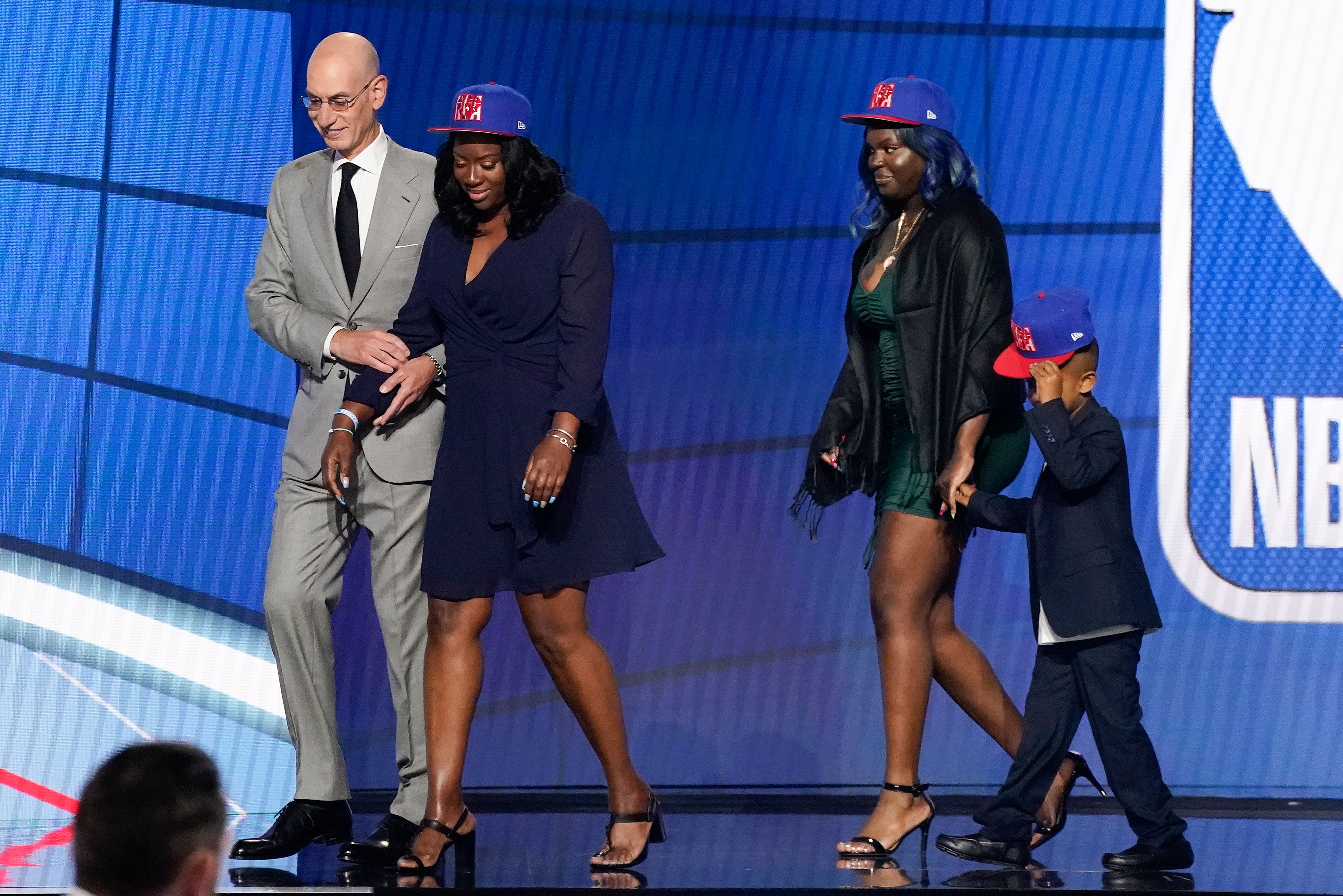 NBA Commissioner Adam Silver escorts relatives of former Kentucky guard Terrence Clarke after a tribute to Clarke during the NBA basketball draft, Thursday, July 29, 2021, in New York. Clarke was killed in a car accident in April 2021. (AP Photo/Corey Sipkin)
