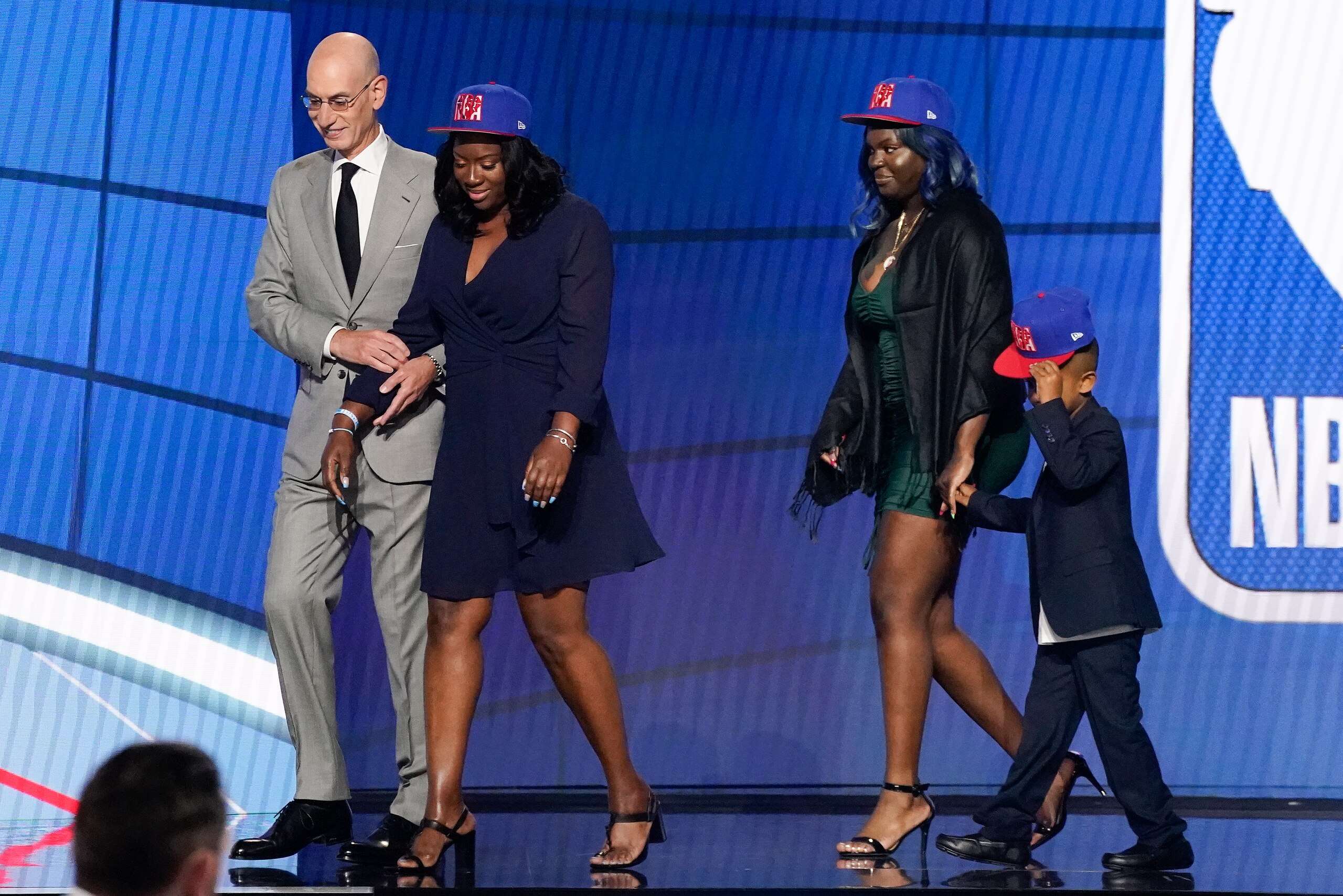 NBA Commissioner Adam Silver escorts relatives of former Kentucky guard Terrence Clarke after a tribute to Clarke during the NBA basketball draft, Thursday, July 29, 2021, in New York. Clarke was killed in a car accident in April 2021. (AP Photo/Corey Sipkin)