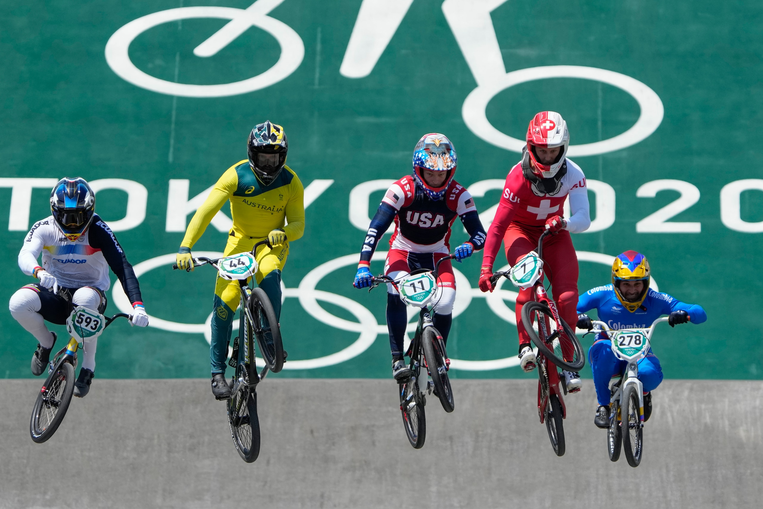 From left, Alfredo Campo of Ecuador, Anthony Dean of Australia, Connor Fields of the United States, David Graf of Switzerland, and Carlos Alberto Ramirez Yepes of Colombia compete in the men's BMX Racing quarterfinals at the 2020 Summer Olympics, Thursday, July 29, 2021, in Tokyo, Japan. (AP Photo/Ben Curtis)