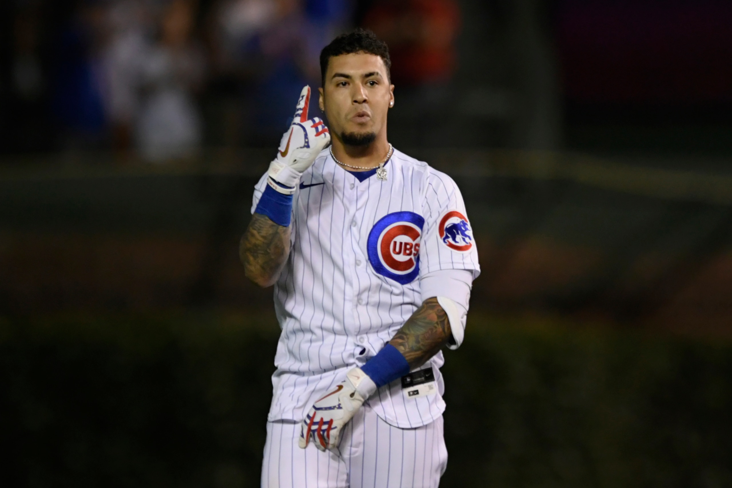 Chicago Cubs' Javier Baez celebrates after hitting a walk-off single in the ninth inning to defeat the Cincinnati Reds 6-5 in a baseball game Monday, July 26, 2021, in Chicago. (AP Photo/Paul Beaty)