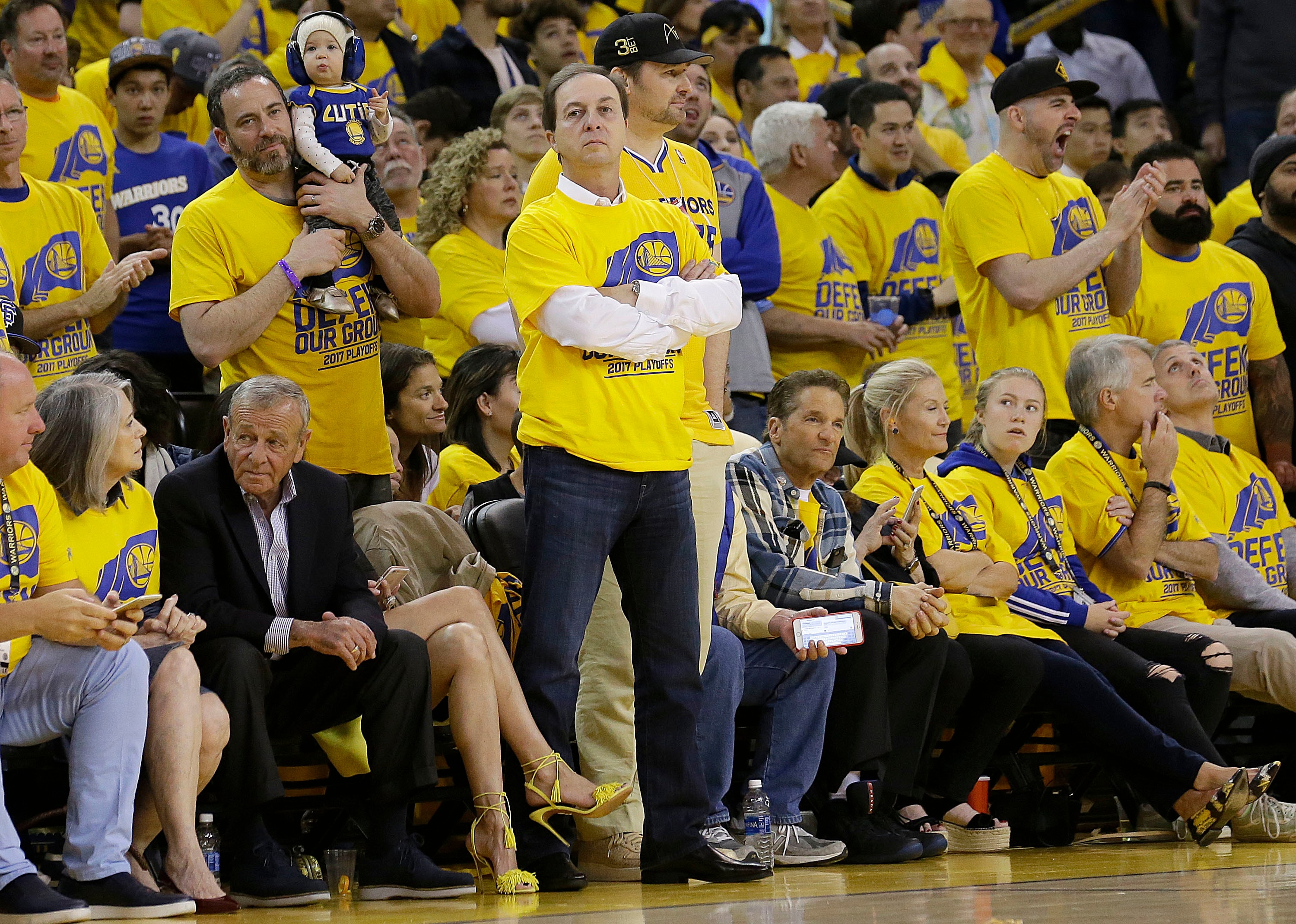 Golden State Warriors owner & CEO Joe Lacob, center, stands during a timeout during the second half of Game 1 of a first-round NBA basketball playoff series between the Warriors and the Portland Trail Blazers in Oakland, Calif., Sunday, April 16, 2017. The Warriors won 121-109. (AP Photo/Jeff Chiu)