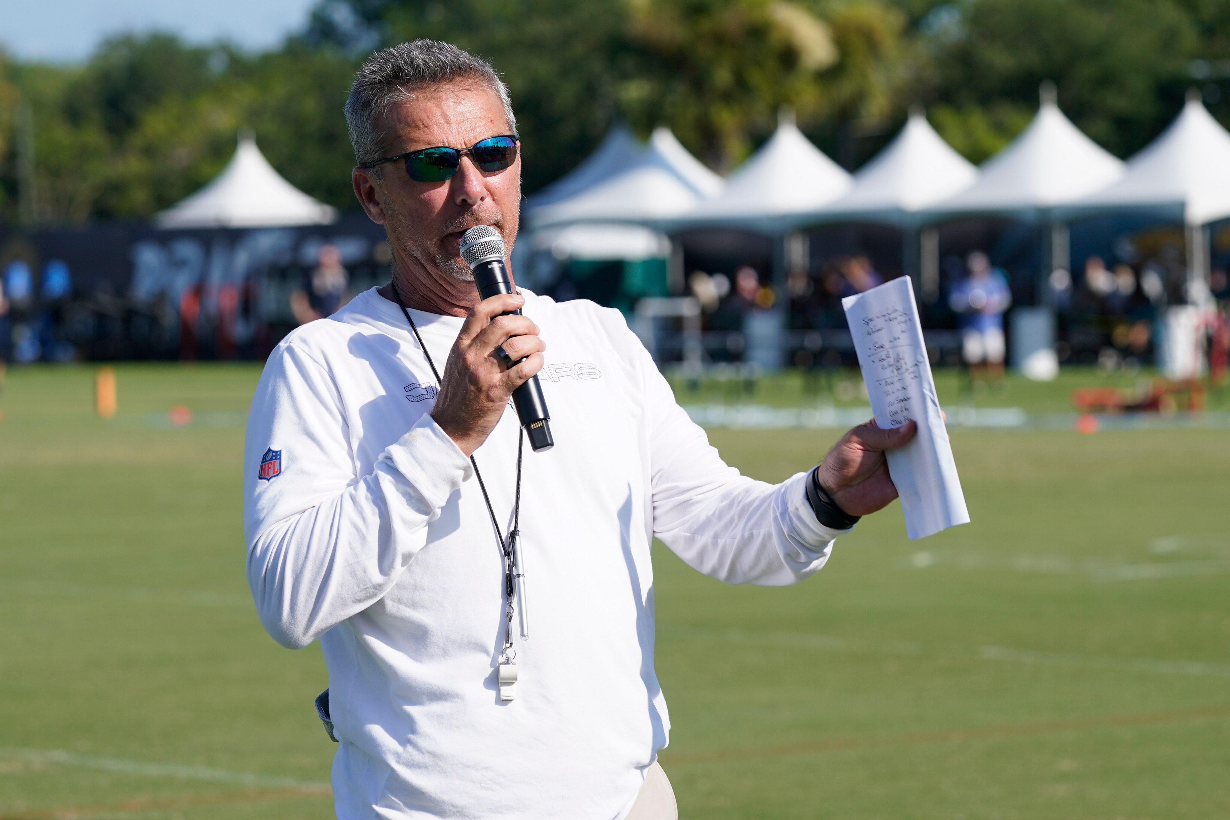 Jacksonville Jaguars head coach Urban Meyer makes remarks to fans before an NFL football practice, Saturday, July 31, 2021, in Jacksonville, Fla. (AP Photo/John Raoux)
