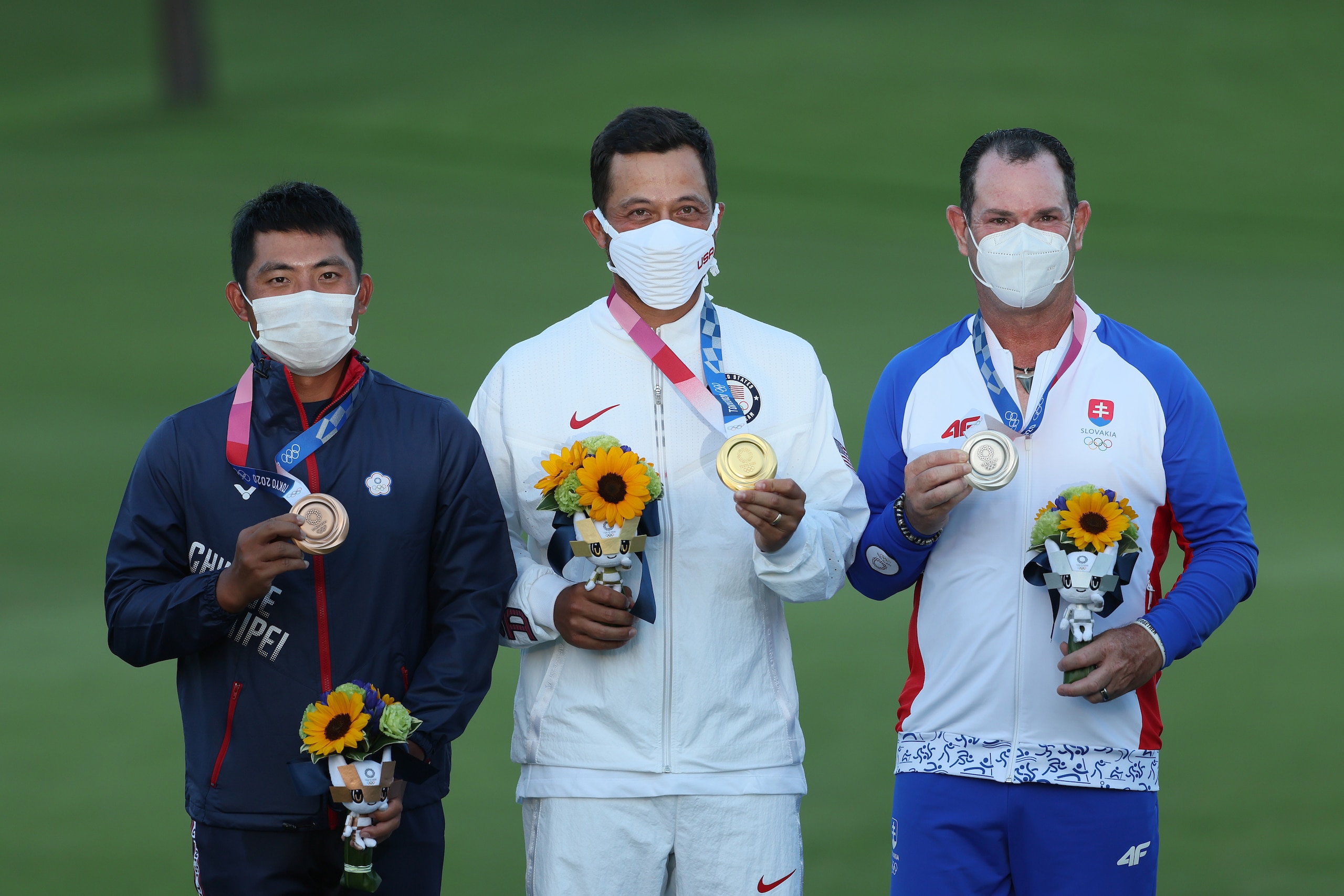 KAWAGOE, JAPAN - AUGUST 01: (L-R) C.T. Pan of Team Chinese Taipei celebrates with the bronze medal, Xander Schauffele of Team United States with the gold medal and Rory Sabbatini of Team Slovakia with the silver medal during the medal ceremony after the final round of the Men's Individual Stroke Play on day nine of the Tokyo 2020 Olympic Games at Kasumigaseki Country Club on August 01, 2021 in Kawagoe, Saitama, Japan. (Photo by Mike Ehrmann/Getty Images)