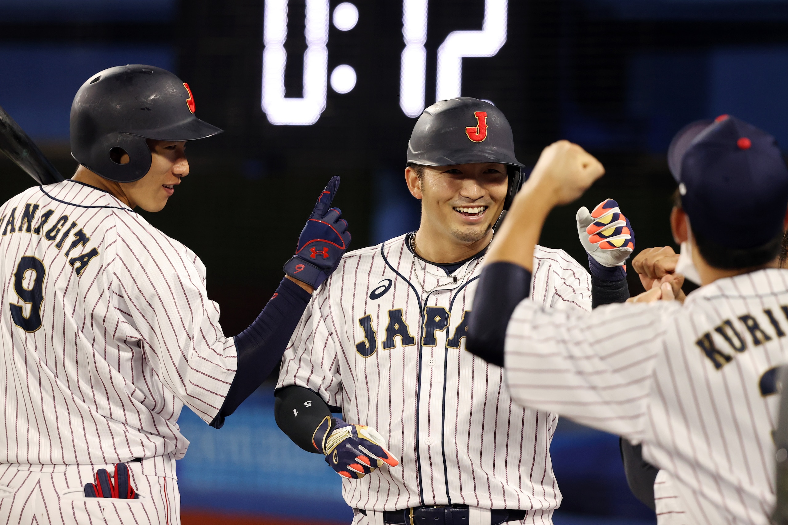 YOKOHAMA, JAPAN - AUGUST 02: Seiya Suzuki #51 of Team Japan returns to the dugout after hitting a solo home run in the fifth inning during the knockout stage of men's baseball on day ten of the Tokyo 2020 Olympic Games at Yokohama Baseball Stadium on August 02, 2021 in Yokohama, Kanagawa, Japan. (Photo by Yuichi Masuda/Getty Images)