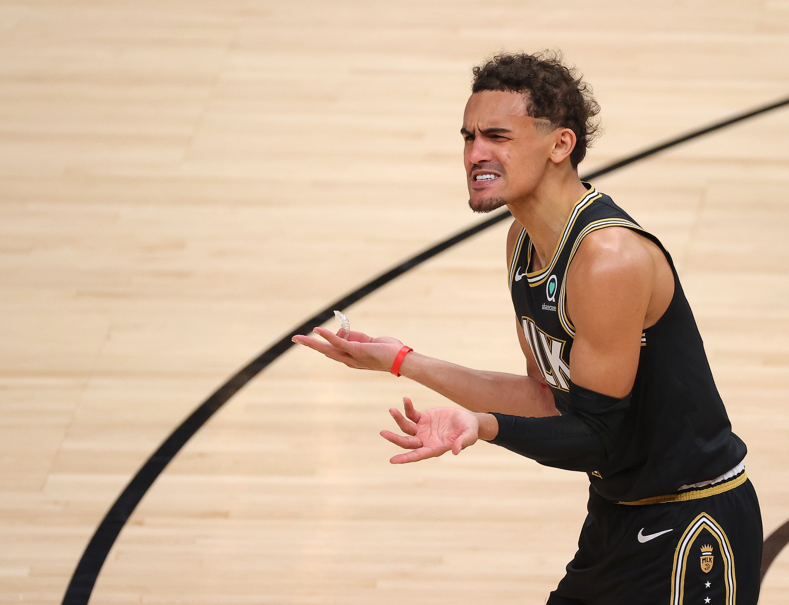 ATLANTA, GEORGIA - JULY 03: Trae Young #11 of the Atlanta Hawks argues a technical foul during the second half in Game Six of the Eastern Conference Finals against the Milwaukee Bucks at State Farm Arena on July 03, 2021 in Atlanta, Georgia NOTE TO USER: User expressly acknowledges and agrees that, by downloading and or using this photograph, User is consenting to the terms and conditions of the Getty Images License Agreement. (Photo by Kevin C. Cox/Getty Images)