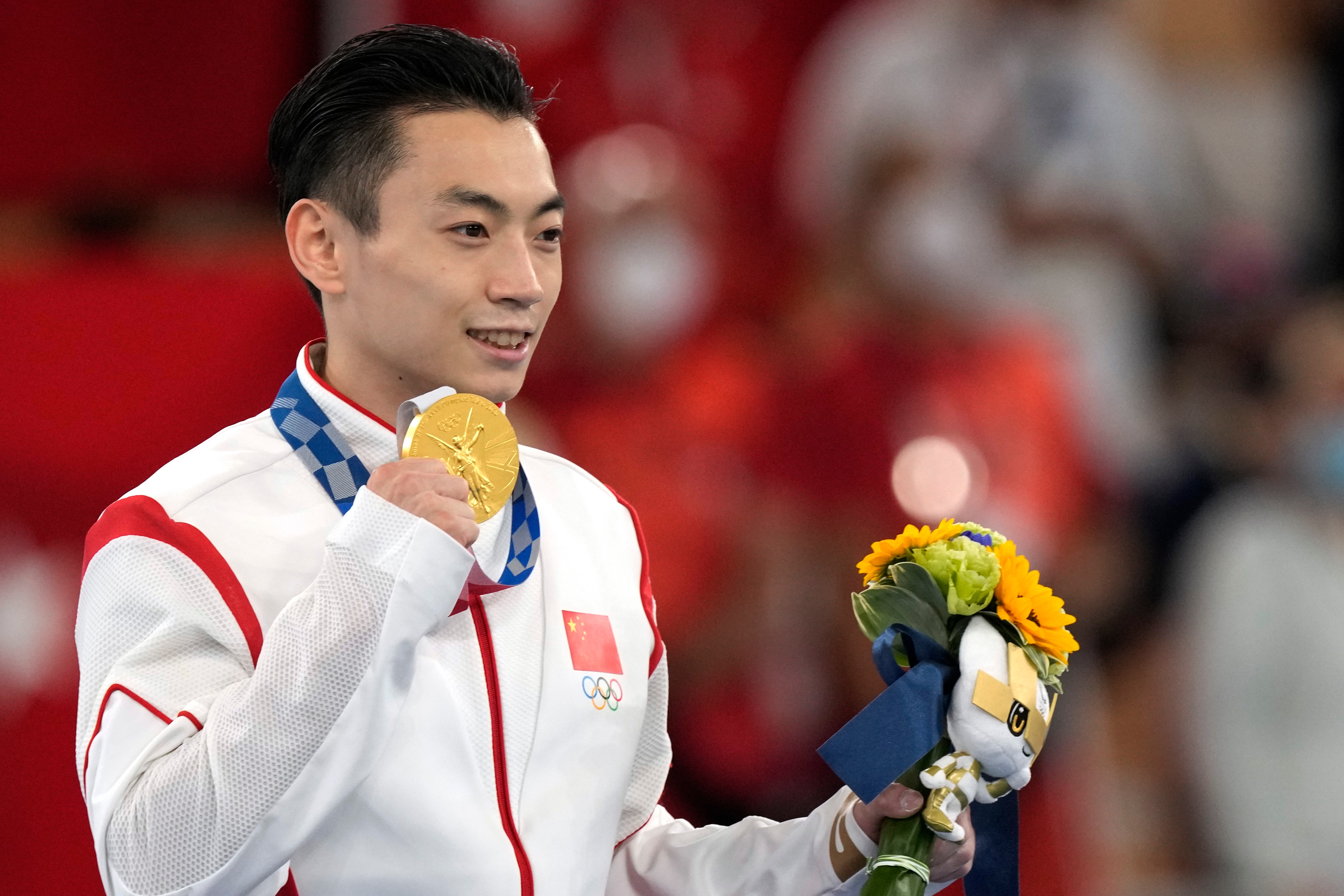China's Zou Jingyuan celebrates after winning the gold medal for the parallel bars during the artistic gymnastics men's apparatus final at the 2020 Summer Olympics, Tuesday, Aug. 3, 2021, in Tokyo, Japan. (AP Photo/Natacha Pisarenko)