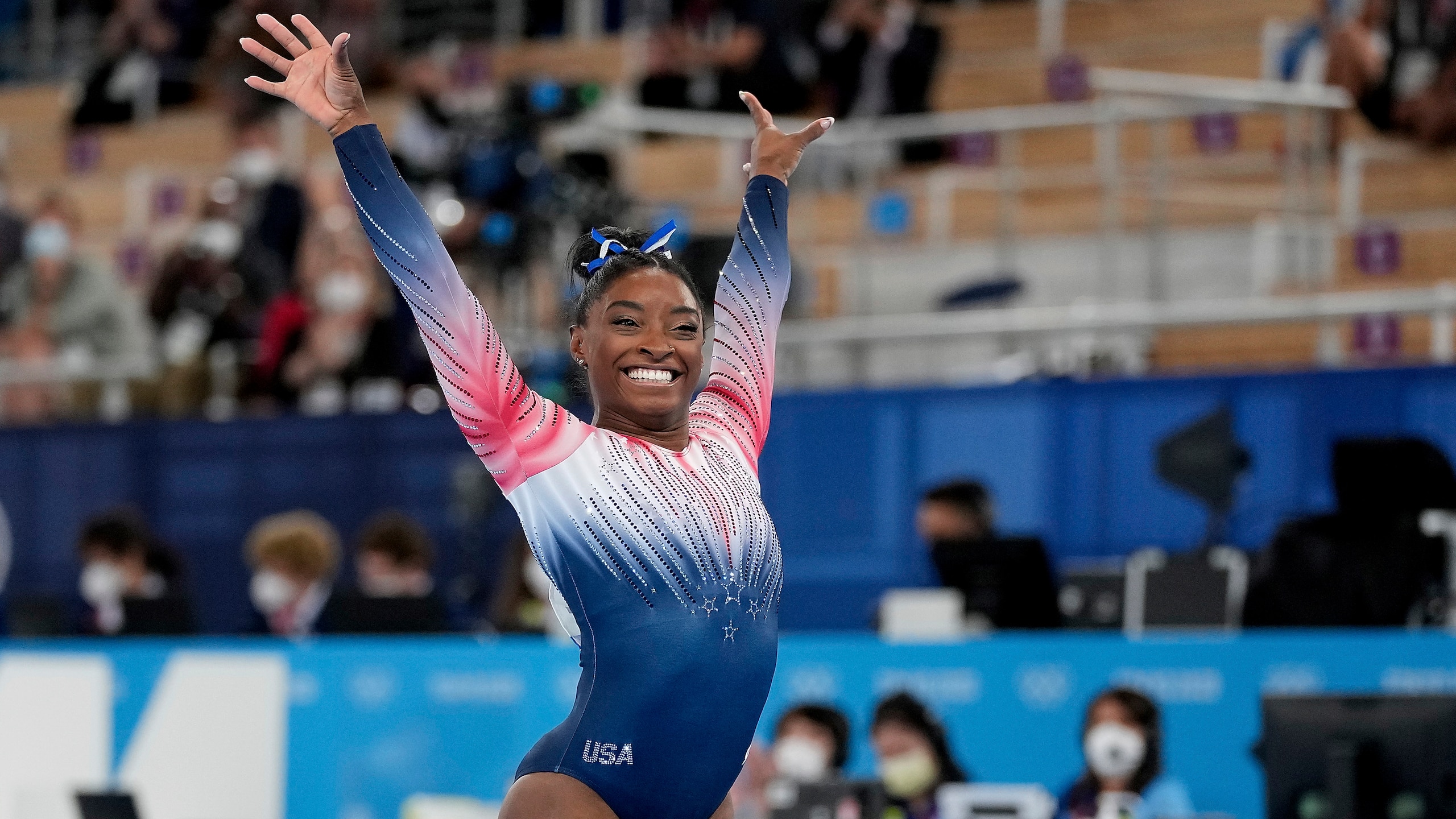 Simone Biles, of the United States, finishes on the balance beam during the artistic gymnastics women's apparatus final at the 2020 Summer Olympics, Tuesday, Aug. 3, 2021, in Tokyo, Japan. (AP Photo/Ashley Landis)