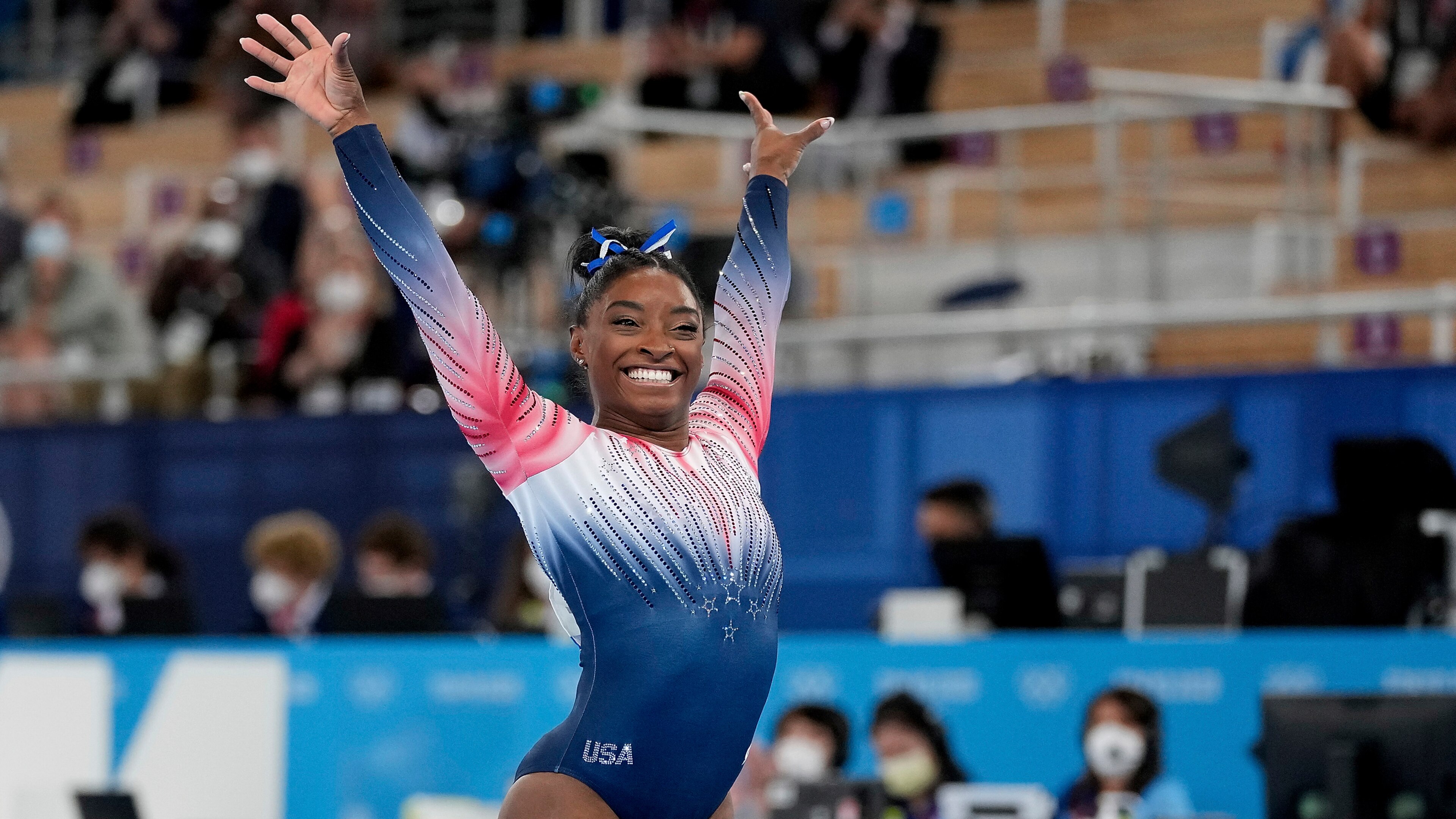 Simone Biles, of the United States, finishes on the balance beam during the artistic gymnastics women's apparatus final at the 2020 Summer Olympics, Tuesday, Aug. 3, 2021, in Tokyo, Japan. (AP Photo/Ashley Landis)
