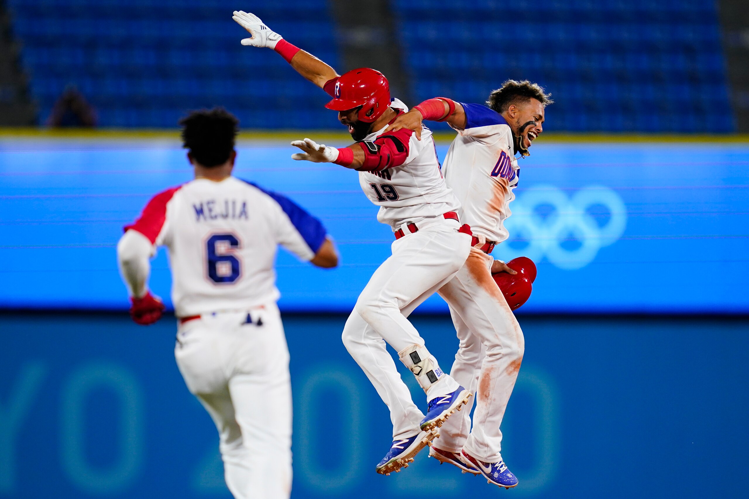 Dominican Republic's Jose Bautista (19) celebrate with Gustavo Nunez after hitting the game winning RBI single during the ninth inning of a baseball game against Israel at the 2020 Summer Olympics, Tuesday, Aug. 3, 2021, in Yokohama, Japan. The Dominican Republic won 7-6. (AP Photo/Matt Slocum)