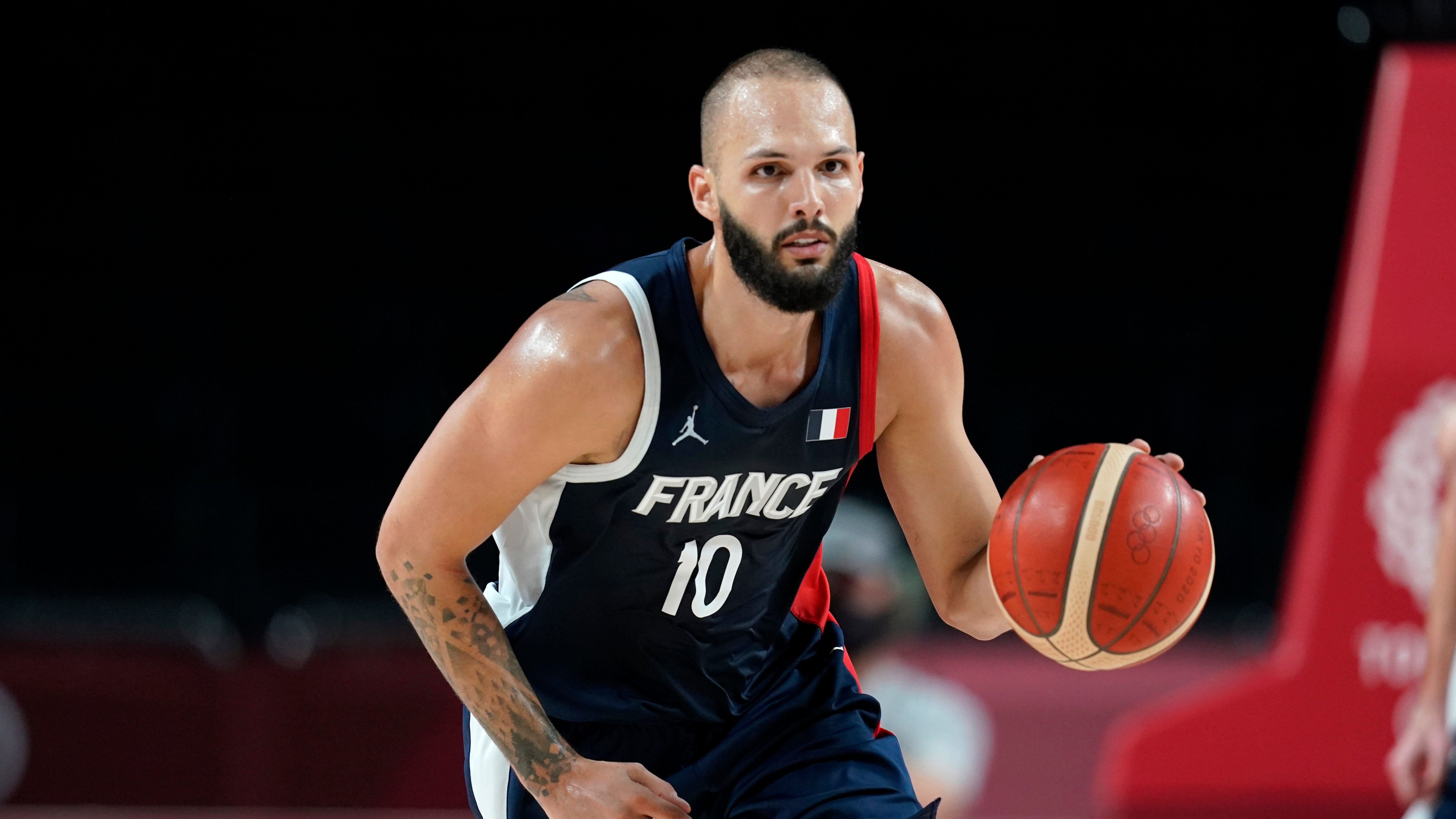 France's Evan Fournier (10) drives up court during a men's basketball quarterfinal round game against Italy at the 2020 Summer Olympics, Tuesday, Aug. 3, 2021, in Saitama, Japan. (AP Photo/Charlie Neibergall)