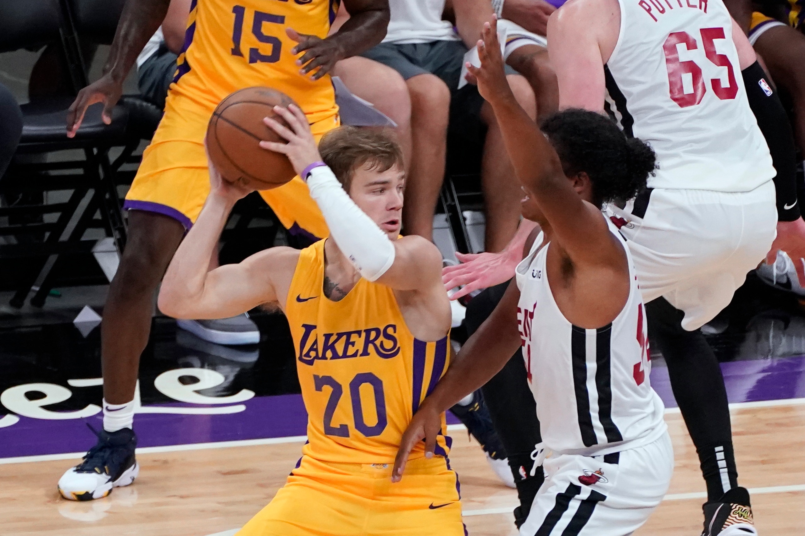 Los Angeles Lakers guard Mac MacClung, left, looks to pass the ball as Miami Heat guard Dru Smith, right, defends during the first half of a California Classic NBA summer league basketball game in Sacramento, Calif., Tuesday, Aug. 3, 2021. (AP Photo/Rich Pedroncelli)