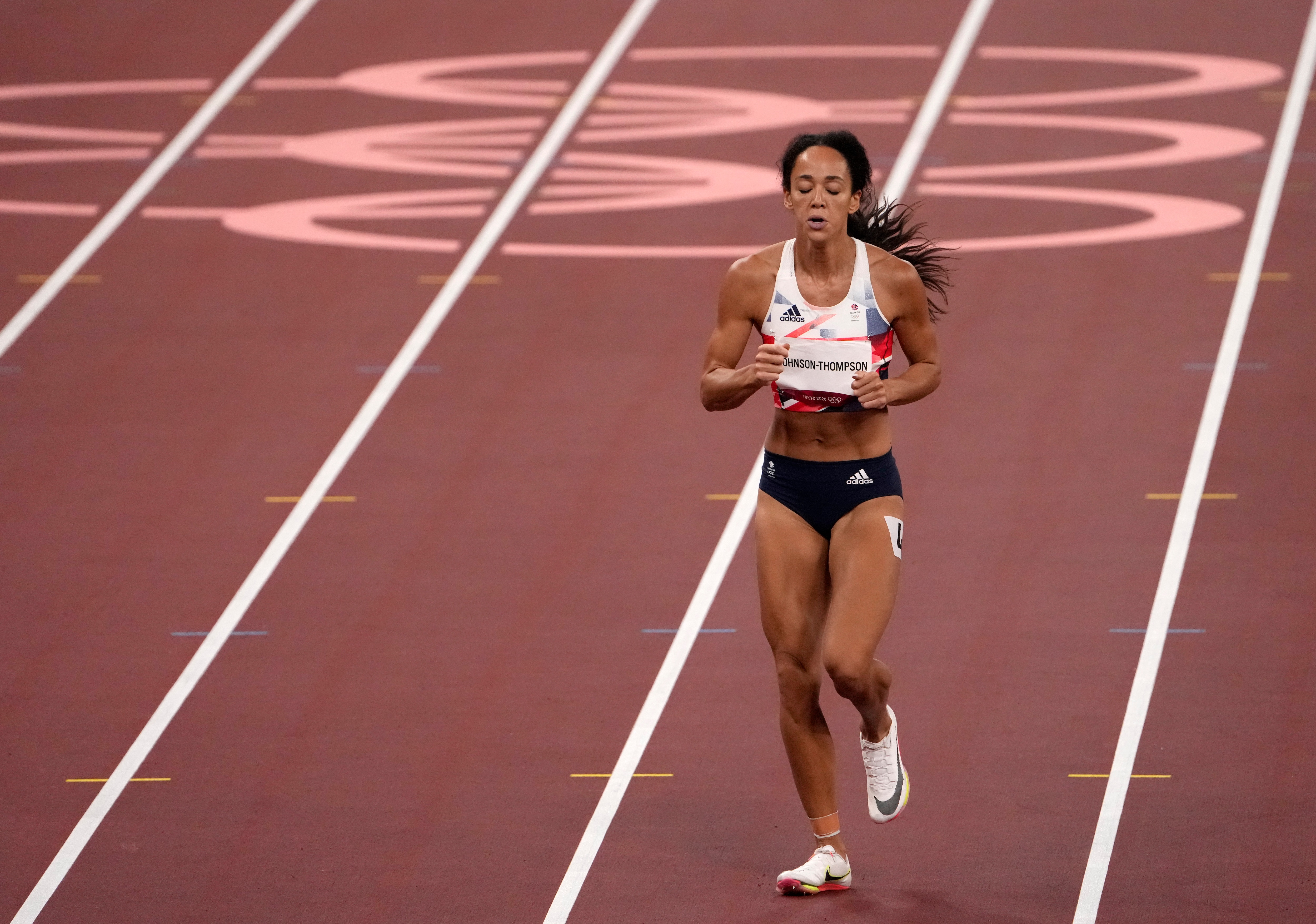 Katarina Johnson-Thompson, of Britain ambles towards the line after pulling up injured in the heptathlon 200-meters at the 2020 Summer Olympics, Wednesday, Aug. 4, 2021, in Tokyo, Japan. (AP Photo/Charlie Riedel)