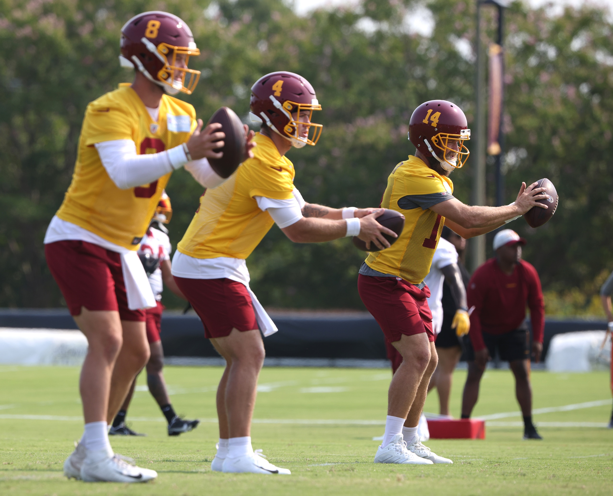 RICHMOND, VIRGINIA - JULY 29: (L-R) Kyle Allen #8, Taylor Heinicke #4 and Ryan Fitzpatrick #14 of the Washington Football Team take part in a quarterback drill during training camp at the Bon Secours Washington Football Team training center park on July 29, 2021 in Richmond, Virginia. (Photo by Kevin Dietsch/Getty Images)