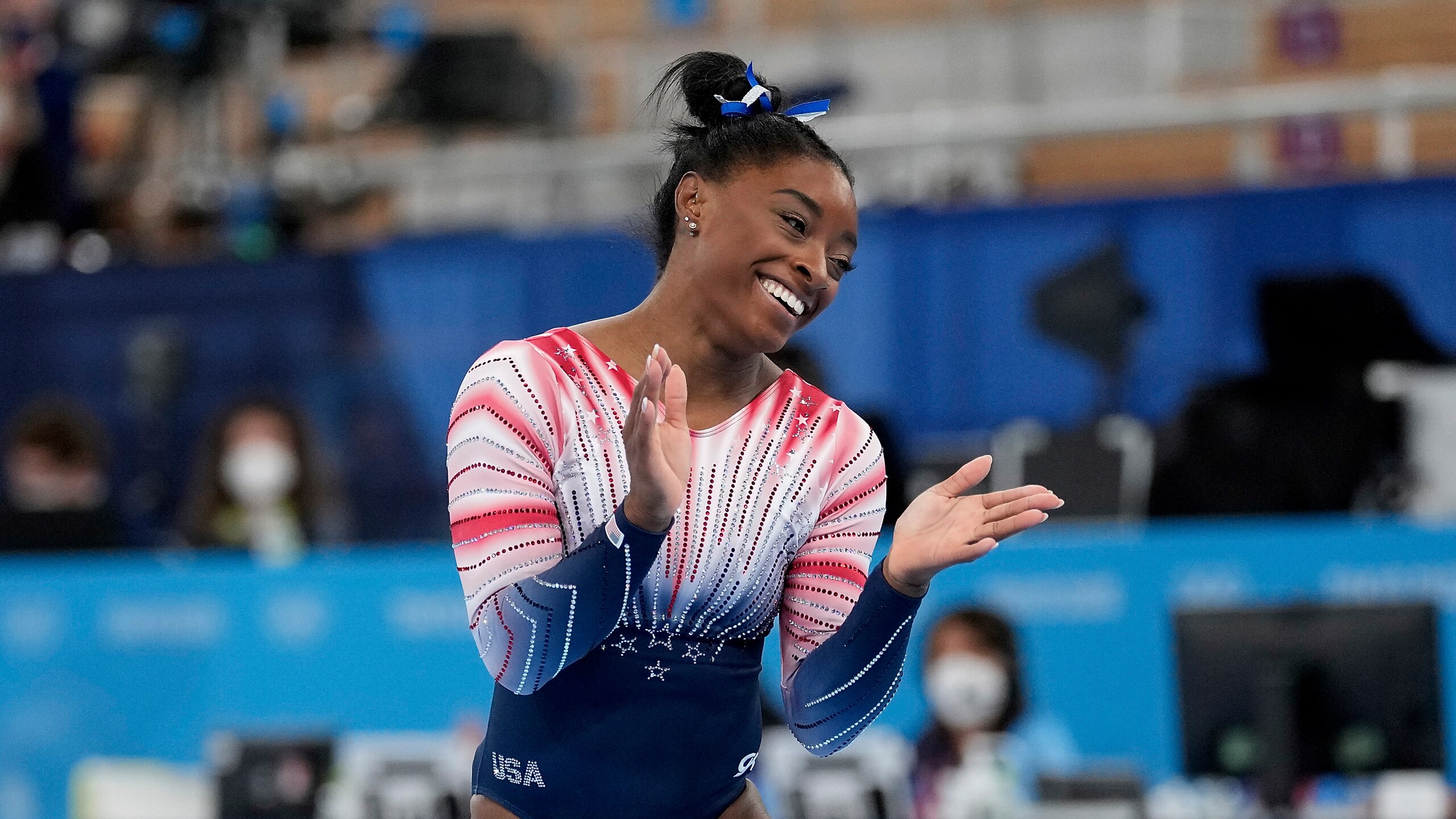 Simone Biles, of the United States, finishes on the balance beam during the artistic gymnastics women's apparatus final at the 2020 Summer Olympics, Tuesday, Aug. 3, 2021, in Tokyo, Japan. (AP Photo/Ashley Landis)