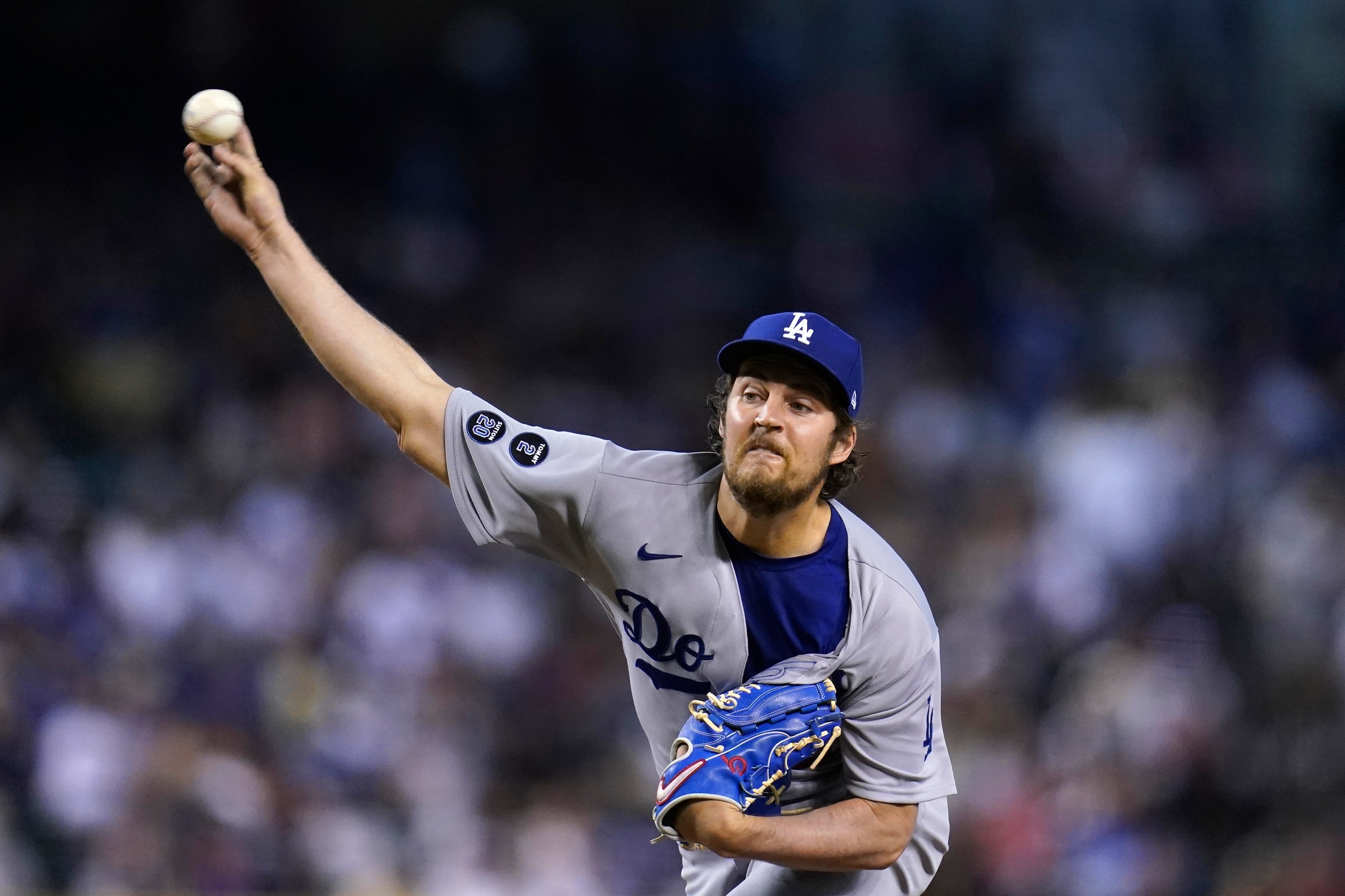 Los Angeles Dodgers starting pitcher Trevor Bauer throws against the Arizona Diamondbacks during the first inning of a baseball game Friday, June 18, 2021, in Phoenix. (AP Photo/Ross D. Franklin)