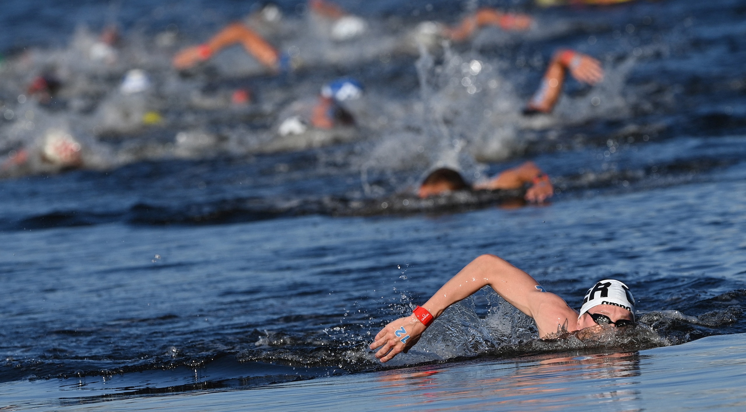 Germany's Florian Wellbrock competes to win and take gold in the men's 10km marathon swimming event during the Tokyo 2020 Olympic Games at the Odaiba Marine Park in Tokyo on August 5, 2021. (Photo by Oli SCARFF / AFP) (Photo by OLI SCARFF/AFP via Getty Images)