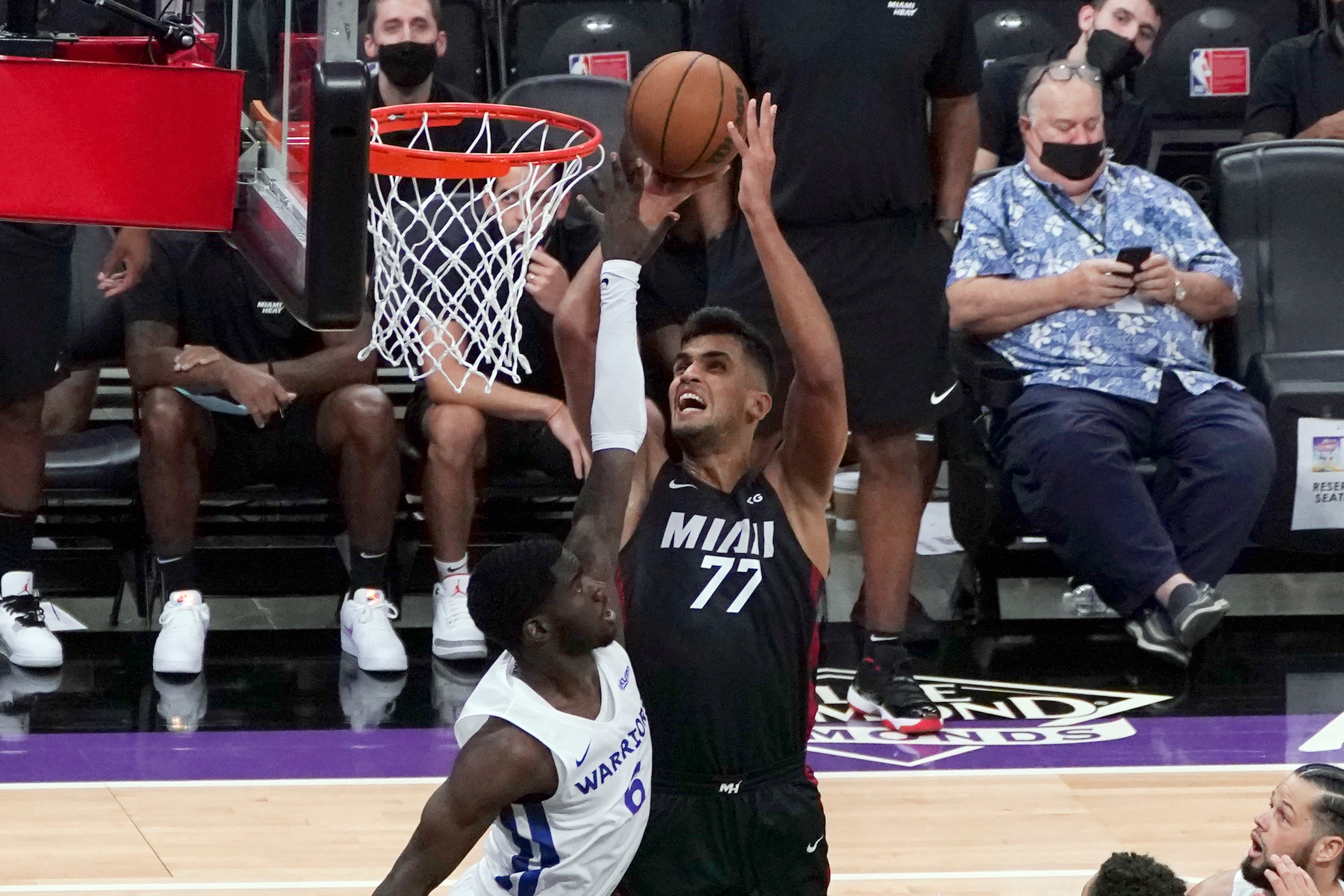 Miami Heat center Omer Yurtseven, right, goes up for the shot against Golden State Warriors forward Kahlil Whitney during the first half of a California Classic NBA summer league basketball game in Sacramento, Calif., Wednesday, Aug. 4, 2021. (AP Photo/Rich Pedroncelli)