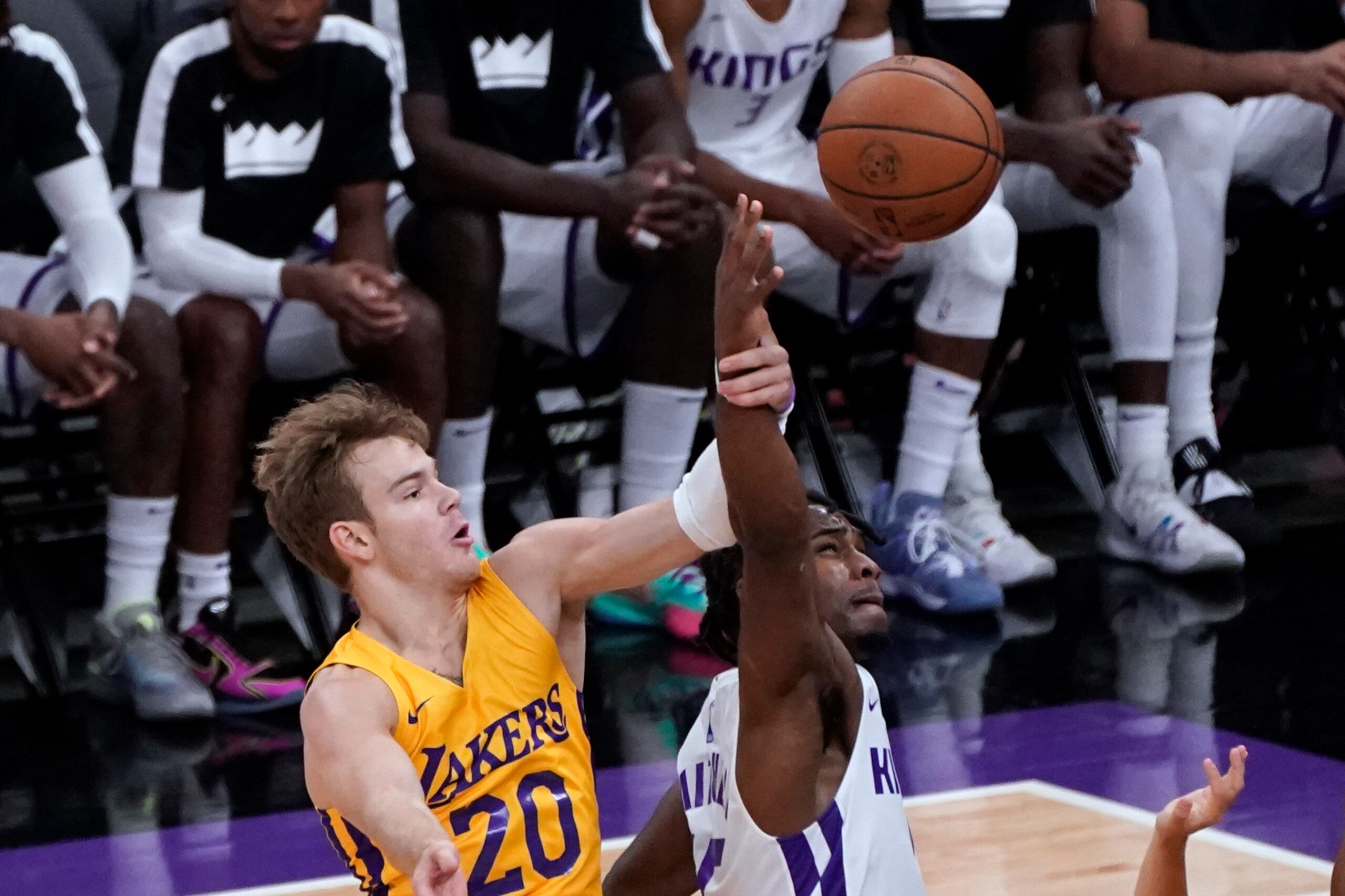 Los Angeles Lakers' Mac McClung, left, and Sacramento Kings; Davion Mitchell go for the ball during the first half of an NBA summer league basketball game in Sacramento, Calif., Wednesday, Aug. 4, 2021. (AP Photo/Rich Pedroncelli)