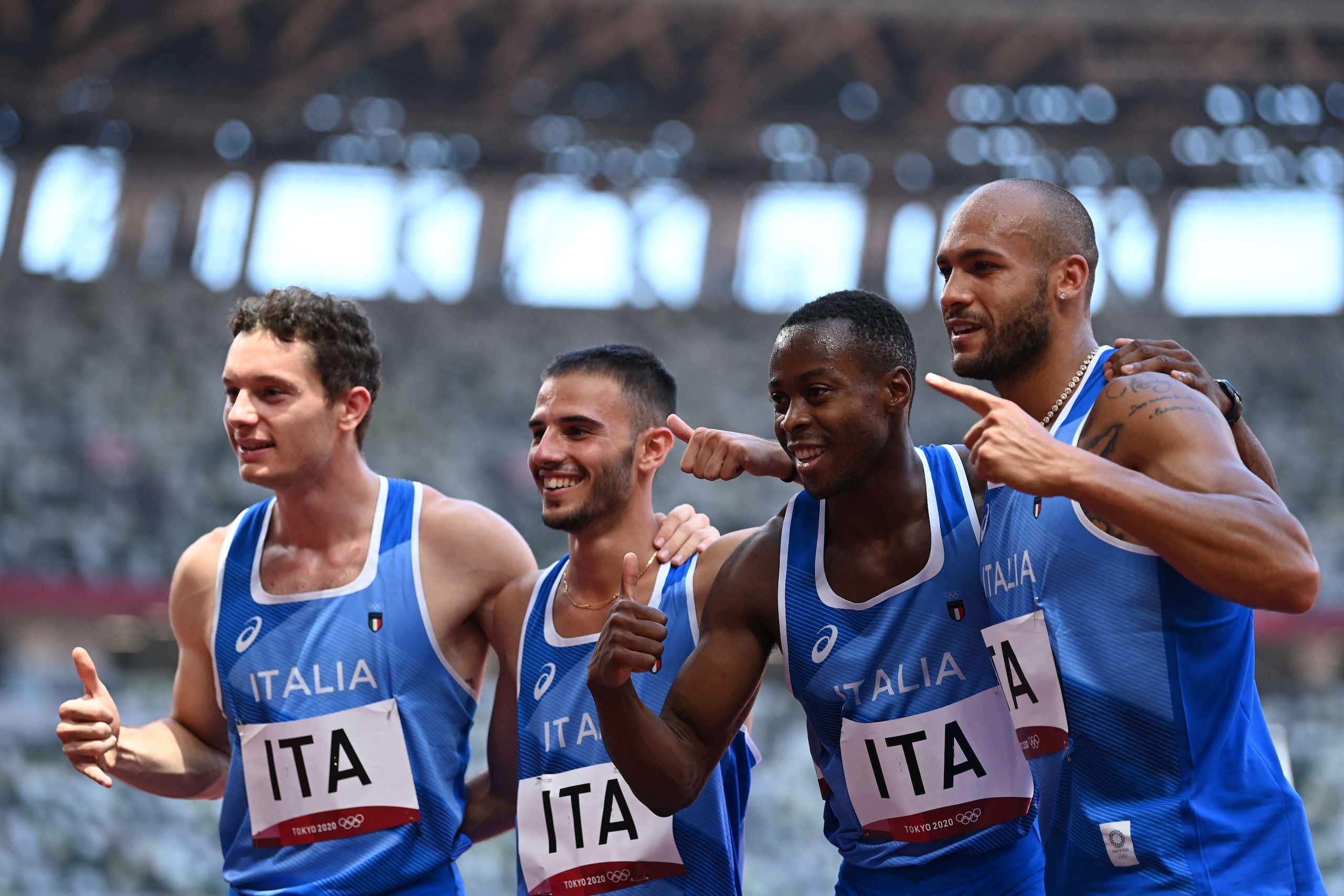 (From L)  Italy's Filippo Tortu, Italy's Lorenzo Patta, Italy's Eseosa Fostine Desalu, and Italy's Lamont Marcell Jacobs pose after taking third place i  the men's 4x100m relay heats during the Tokyo 2020 Olympic Games at the Olympic Stadium in Tokyo on August 5, 2021. (Photo by Jonathan NACKSTRAND / AFP) (Photo by JONATHAN NACKSTRAND/AFP via Getty Images)