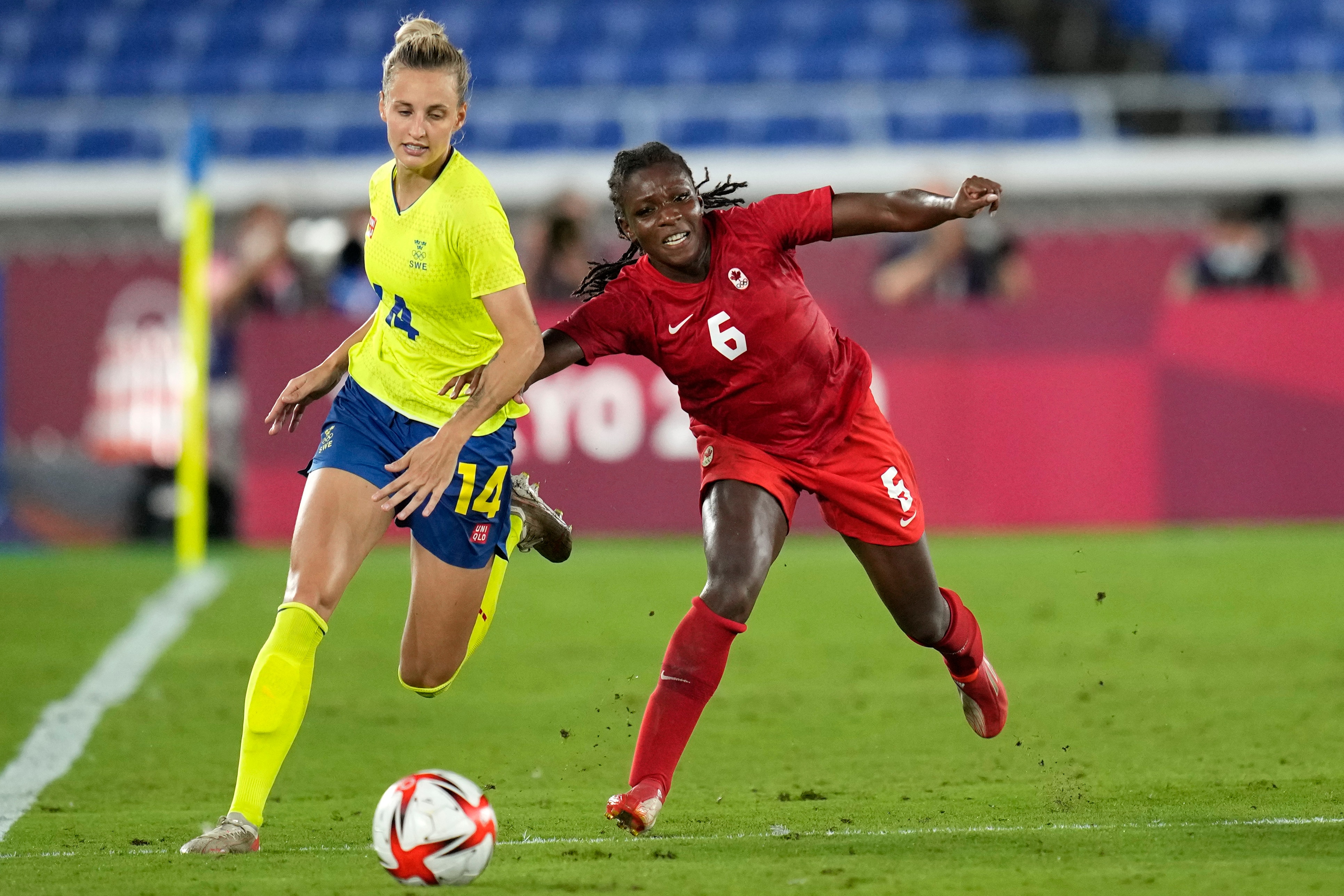Canada's Deanne Rose, right, and Sweden's Nathalie Bjorn battle for the ball during the women's final soccer match at the 2020 Summer Olympics, Friday, Aug. 6, 2021, in Yokohama, Japan. (AP Photo/Andre Penner)